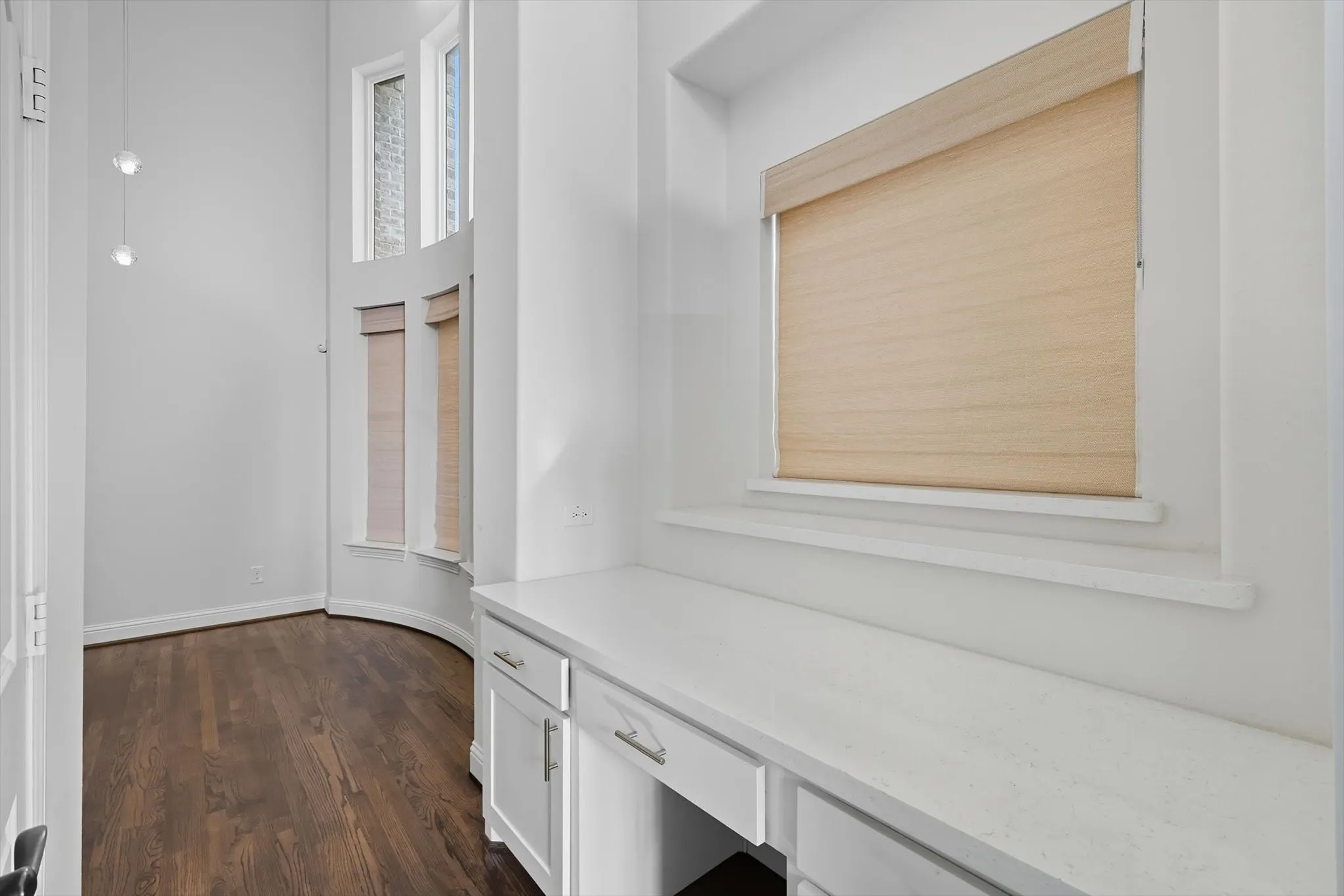 Mudroom featuring dark wood finished floors and baseboards