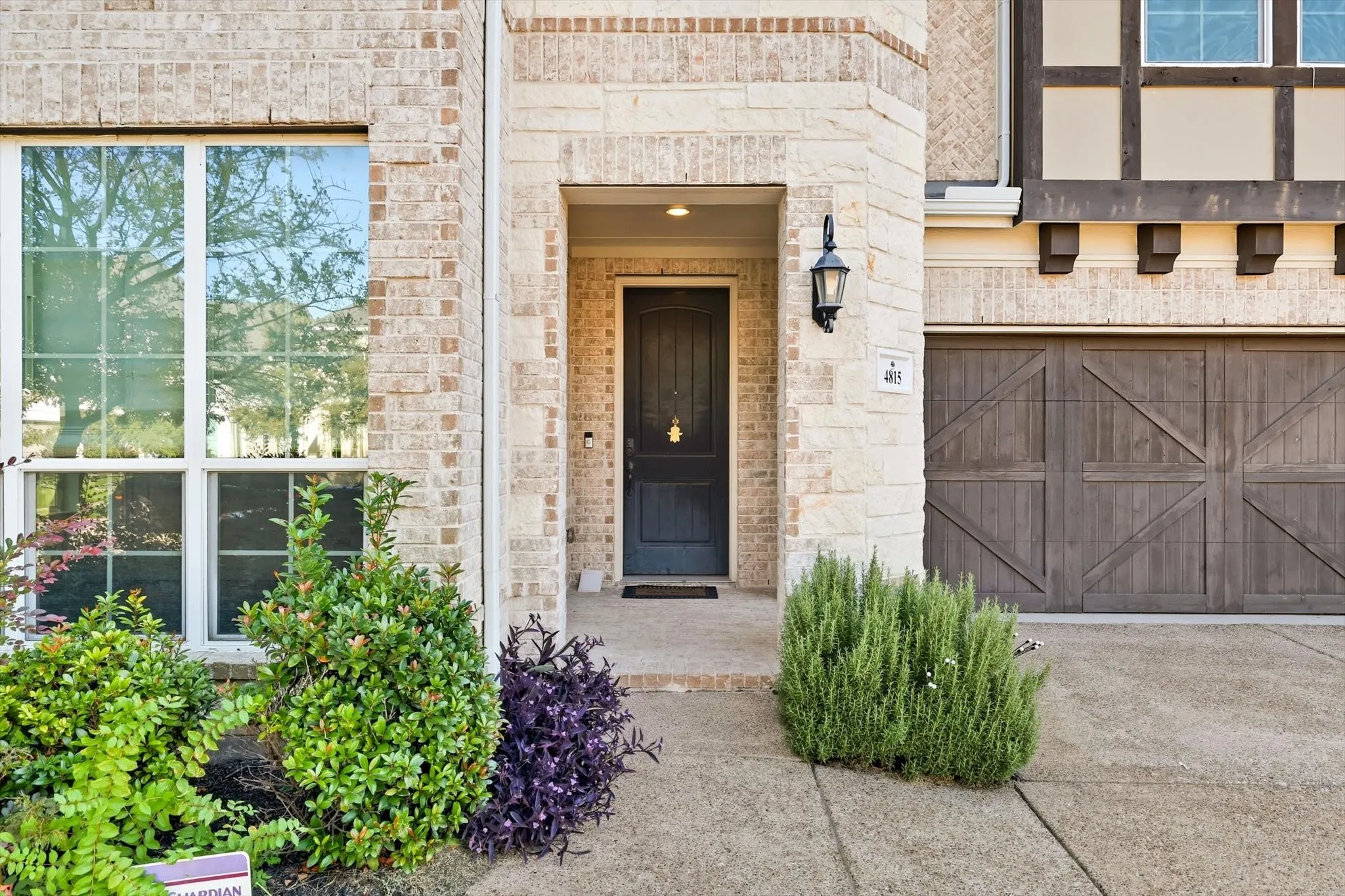 Doorway to property with stone siding and brick siding