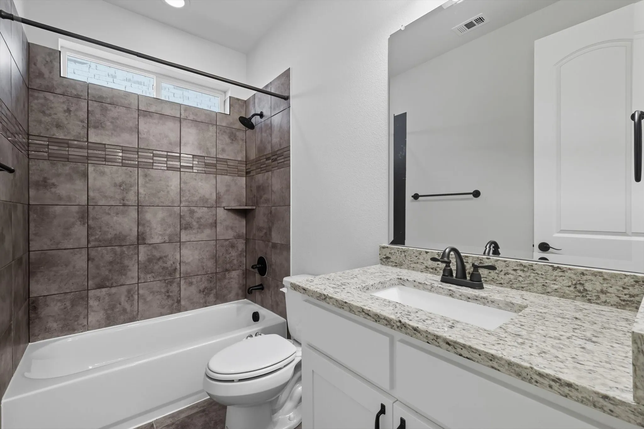 Full bath featuring shower / washtub combination and vanity