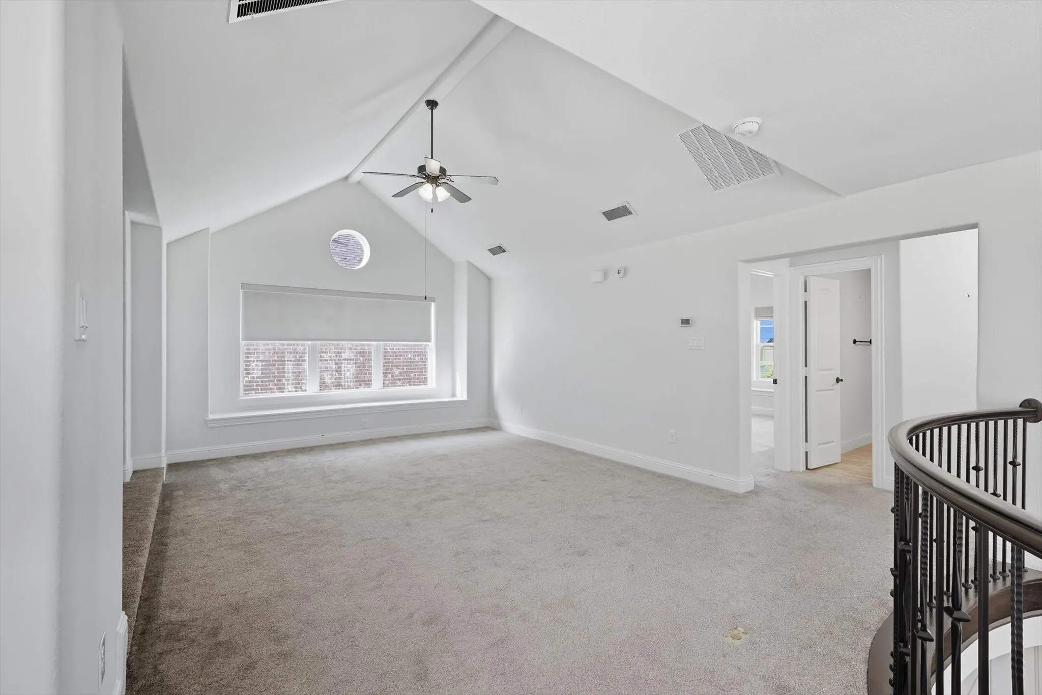 Empty room with light carpet and a ceiling fan