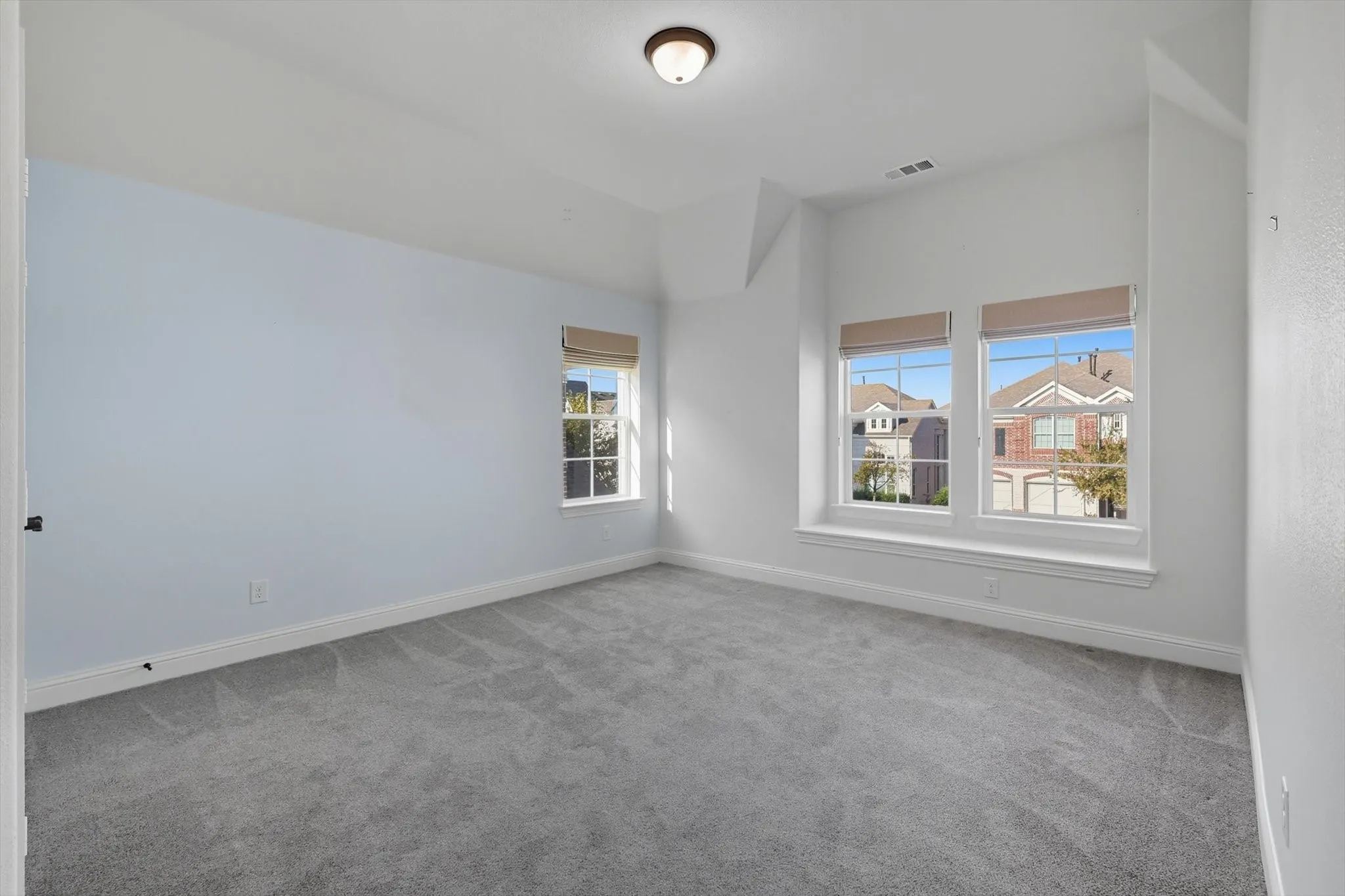 Unfurnished room with light colored carpet and baseboards