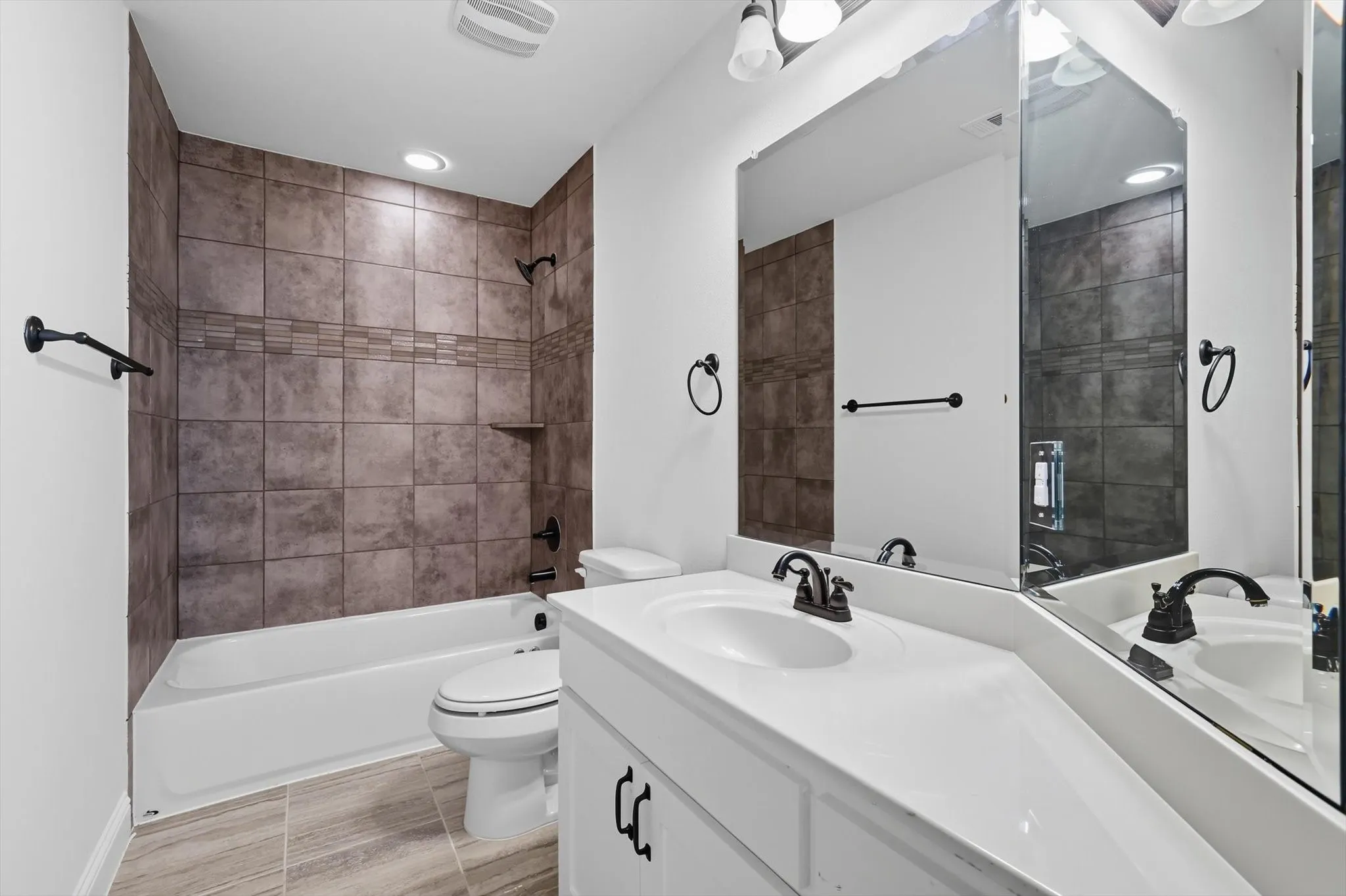 Bathroom with double vanity and shower / bathtub combination