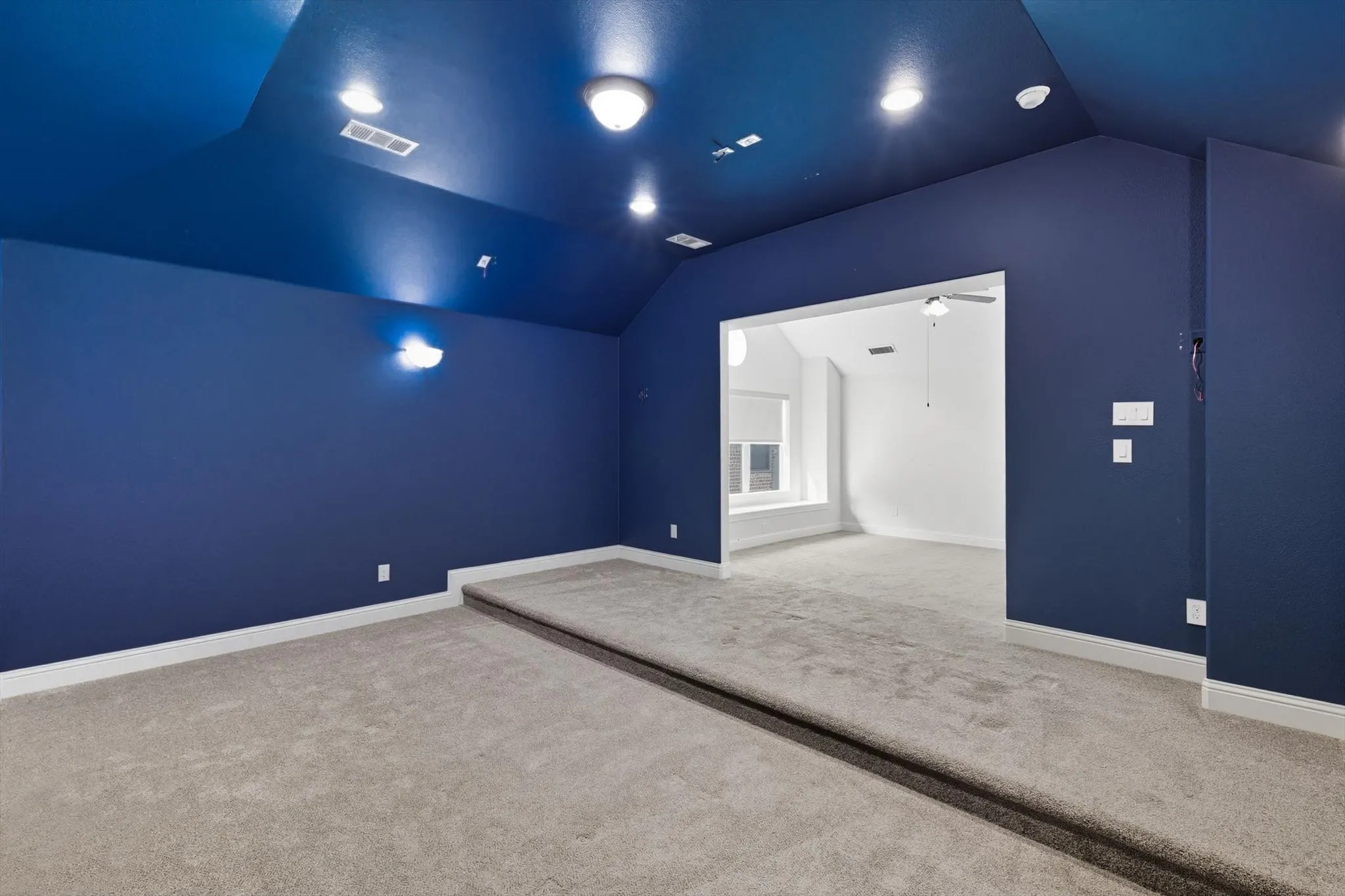 Bonus room with lofted ceiling and carpet