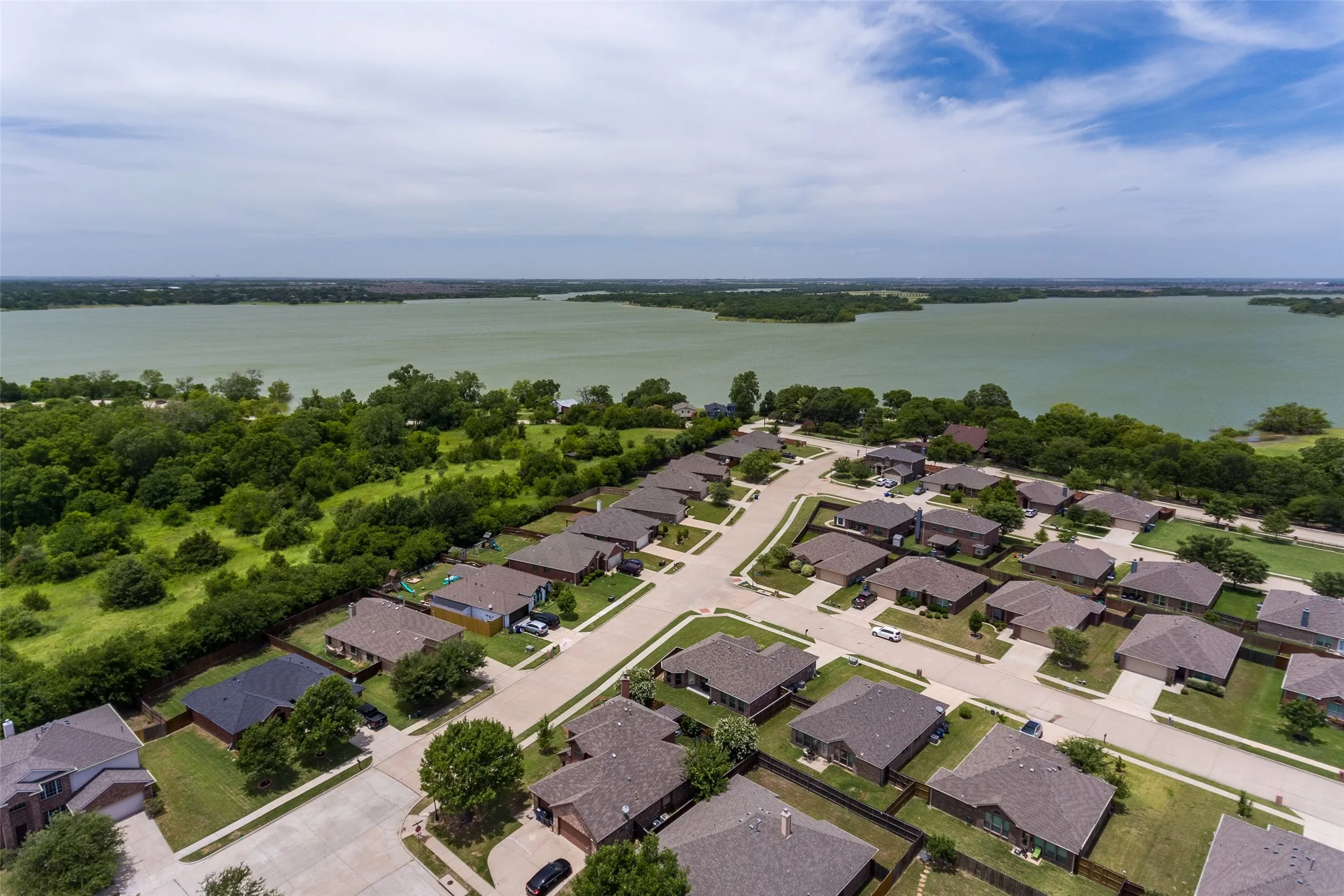 Lakefront community with established homes, paved streets, and mature trees