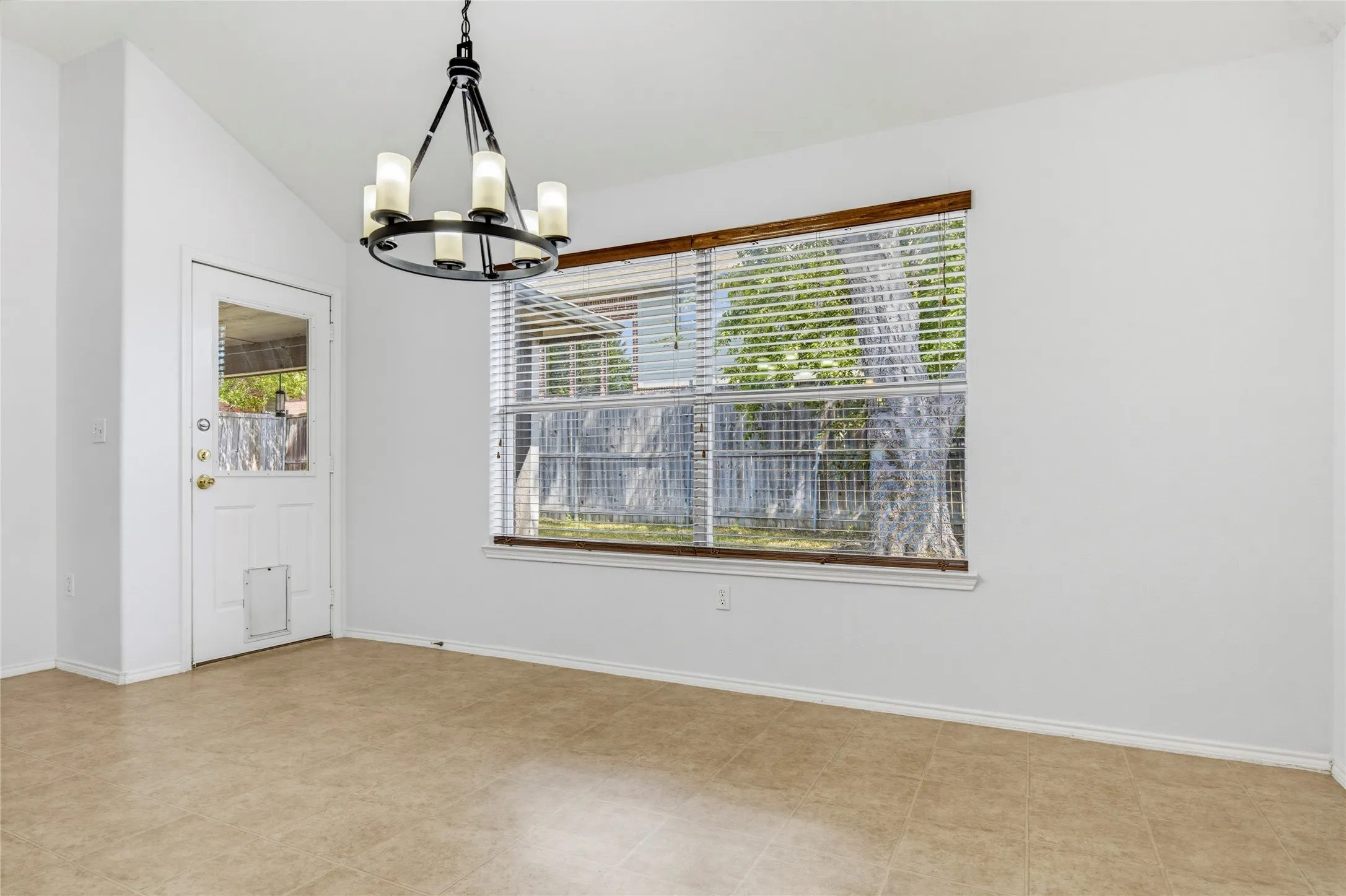 Vaulted ceiling with an overhead chandelier