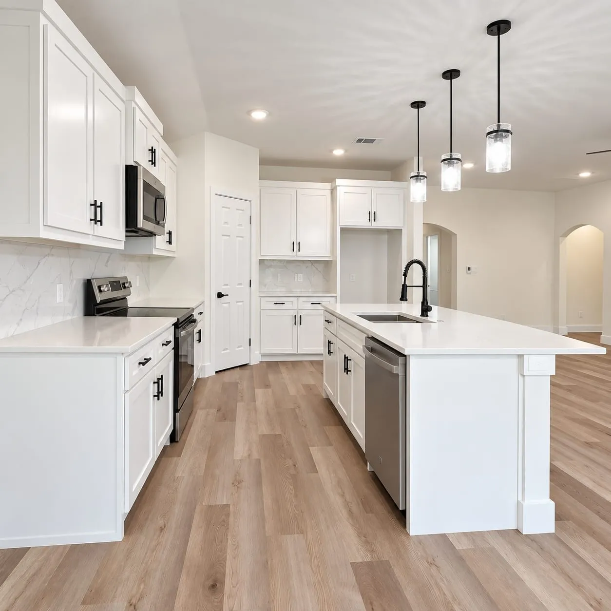 Kitchen featuring white cabinetry, light countertops, wood-finish flooring, recessed lighting, and a kitchen island with pendant lighting