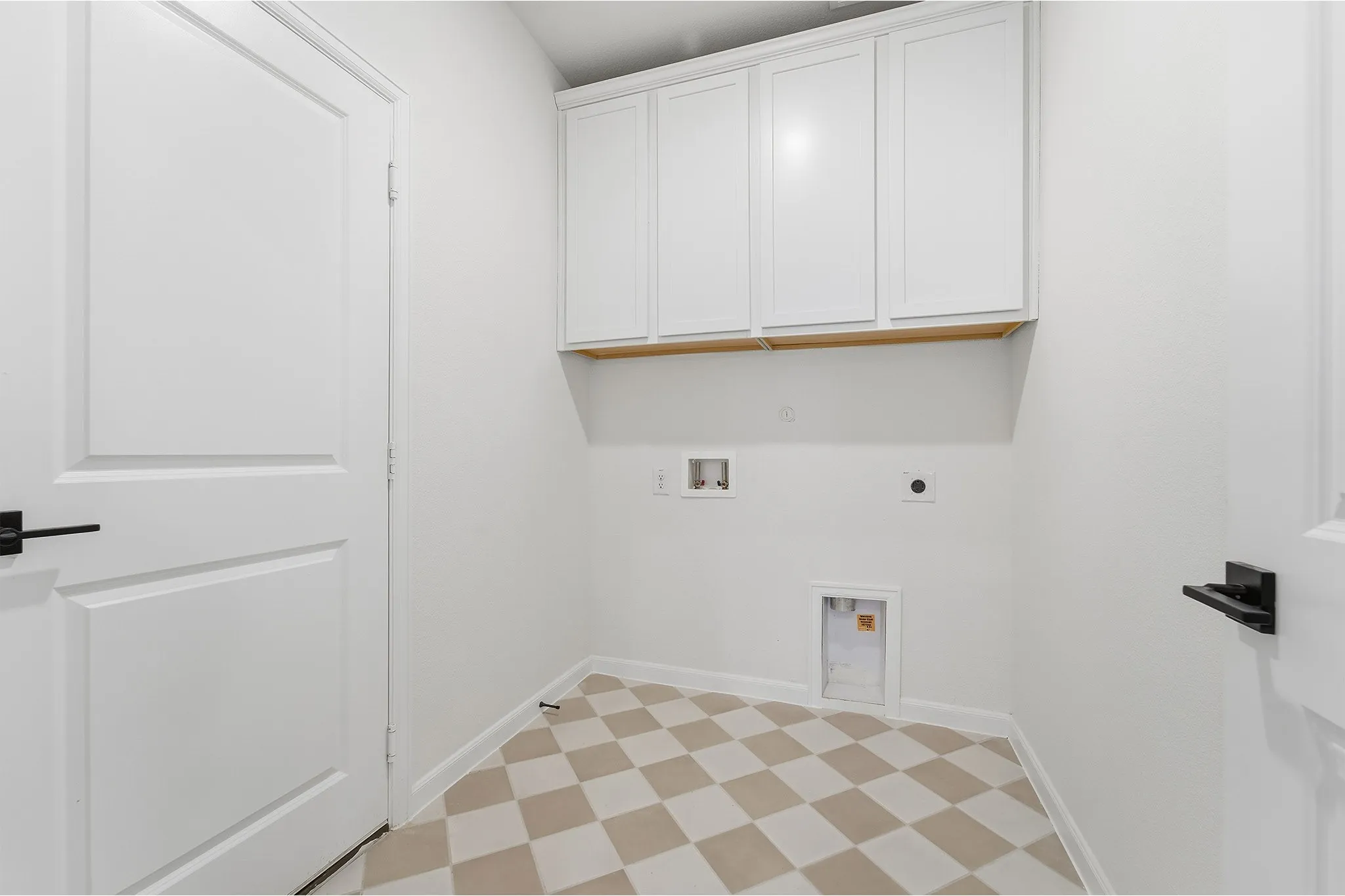 White shaker-style cabinetry with wood-finish shelving