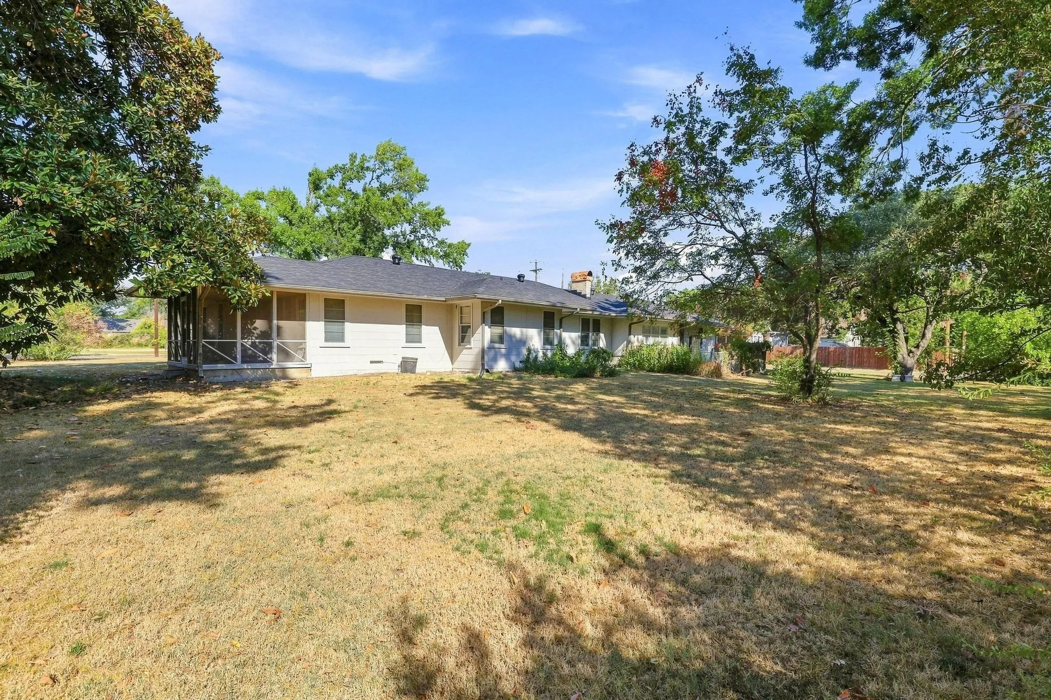Expansive property with a screened-in porch and a class 4 shingled roof.