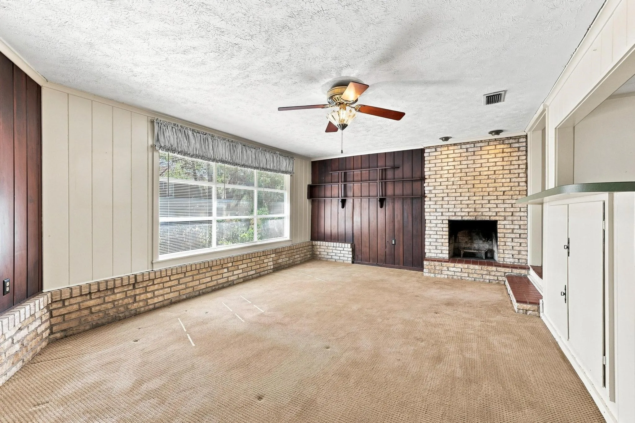 Brick fireplace with integrated hearth seating.