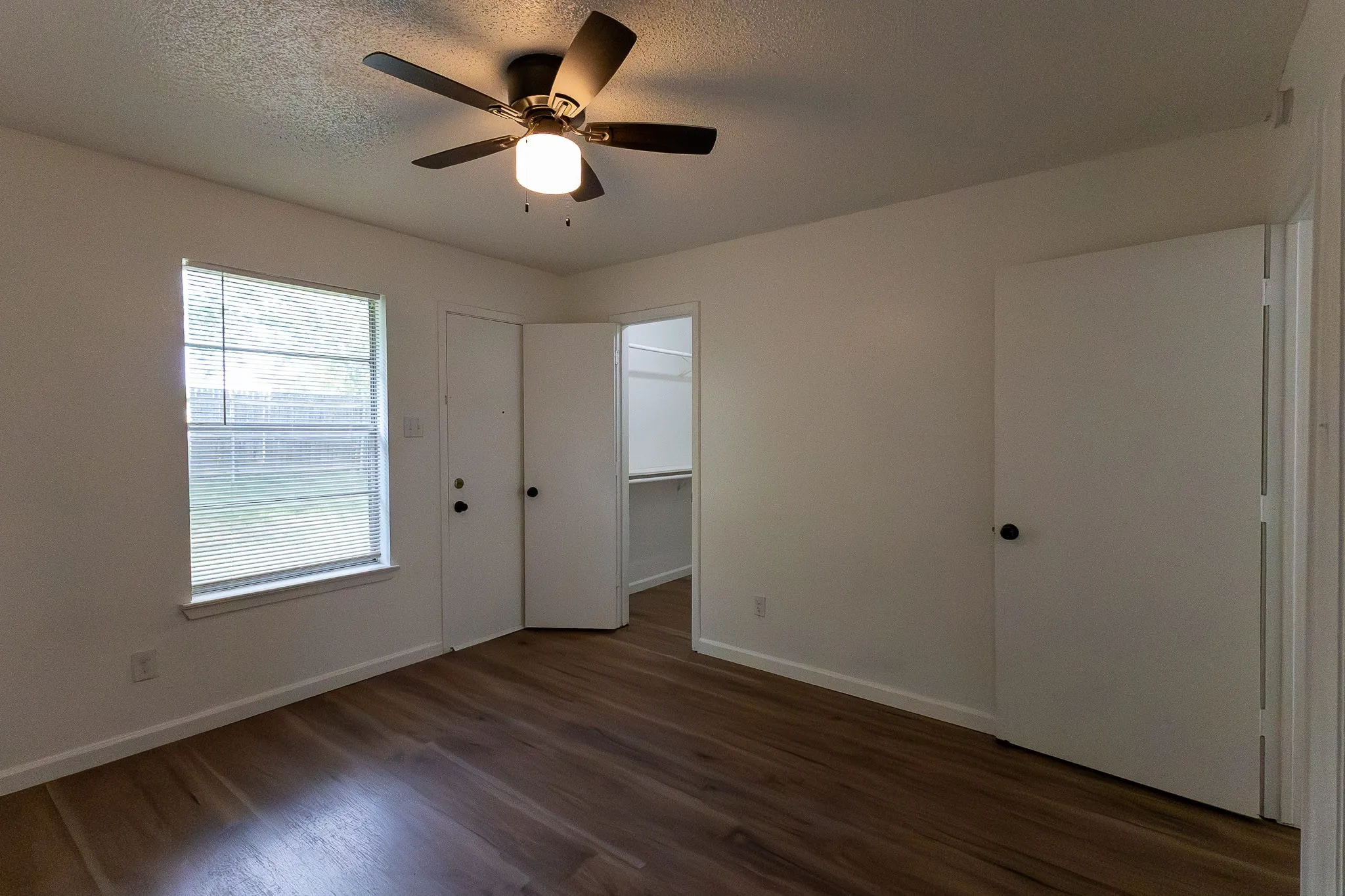 Wood-finish flooring throughout the room
