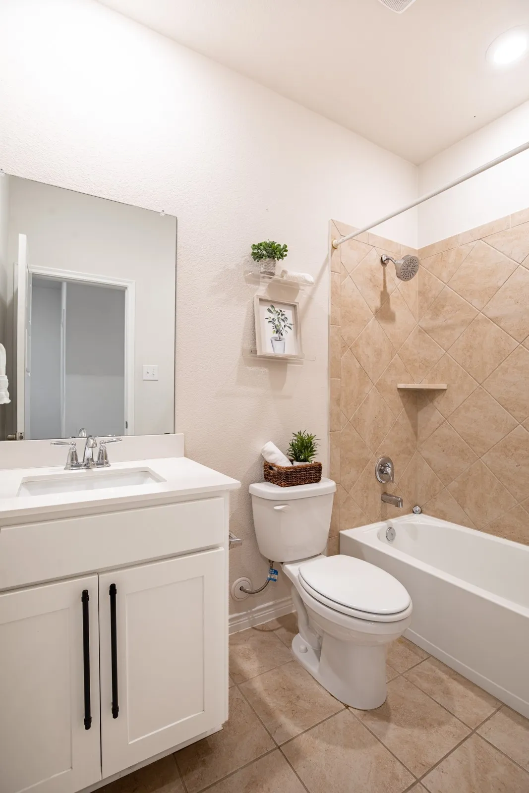 White vanity with a single basin sink and brushed nickel faucet