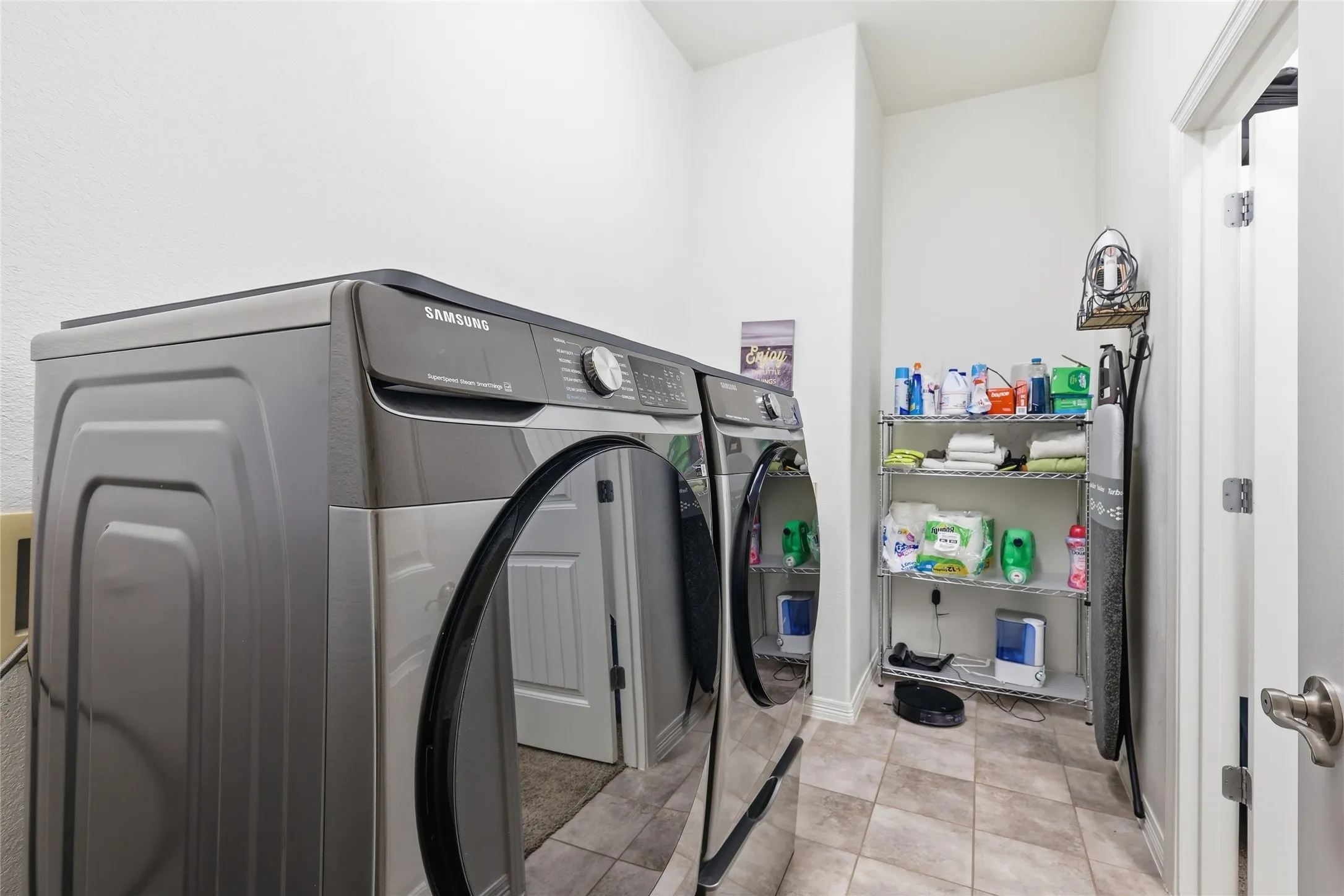 Utility room featuring tiled flooring and neutral wall tones