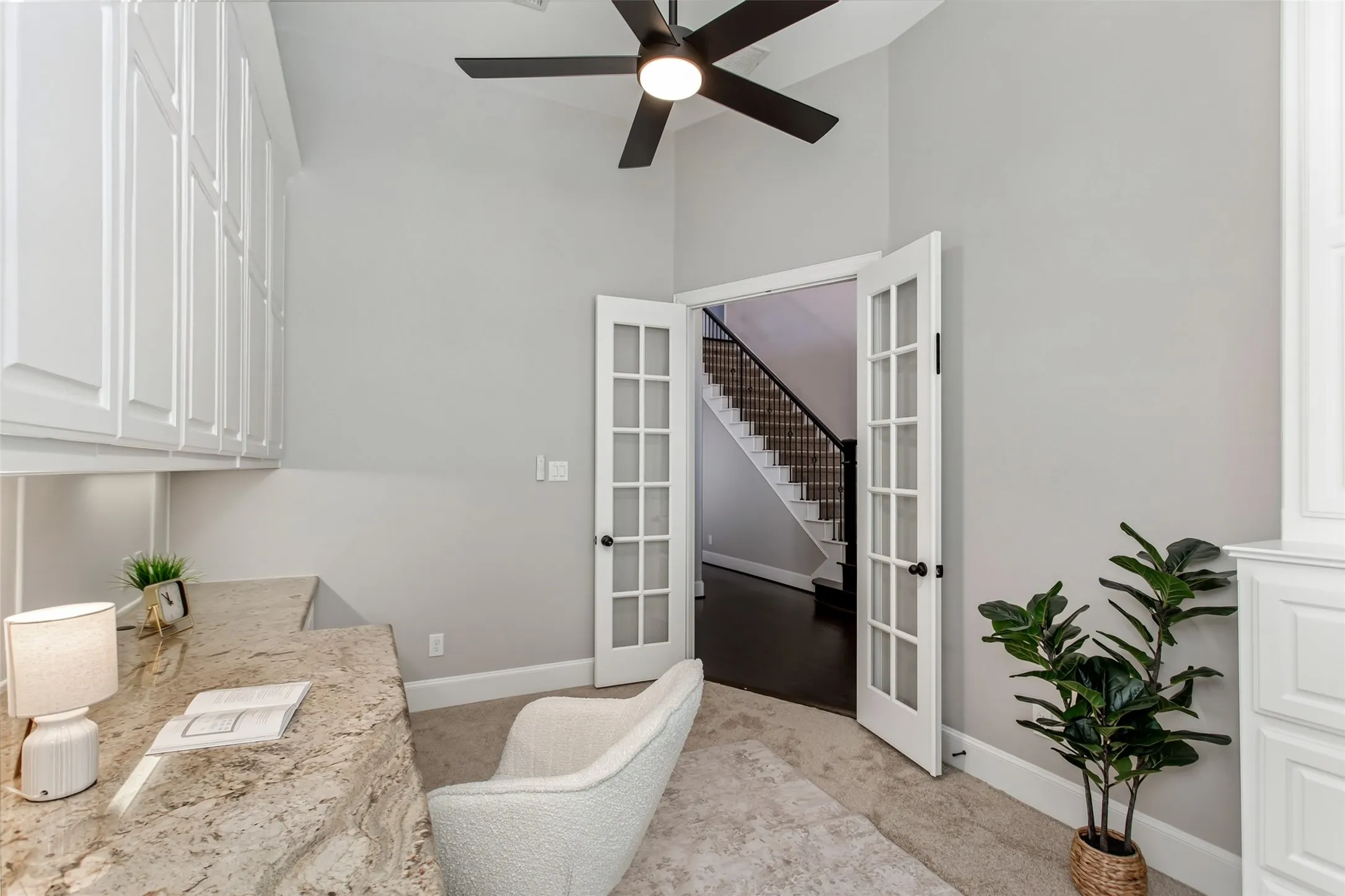 French doors with divided glass panes close the study off from the foyer for quiet work and calls.
Granite desk surface and full-height built-in cabinets provide storage on both sides of the room.
