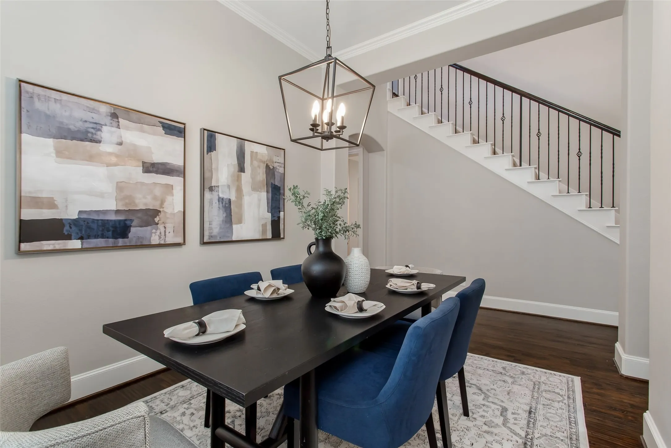 Formal dining opens to the two-story foyer, where an arched clerestory window and a new 2026
chandelier bring in light. Hand-scraped hardwoods run continuously through both spaces.