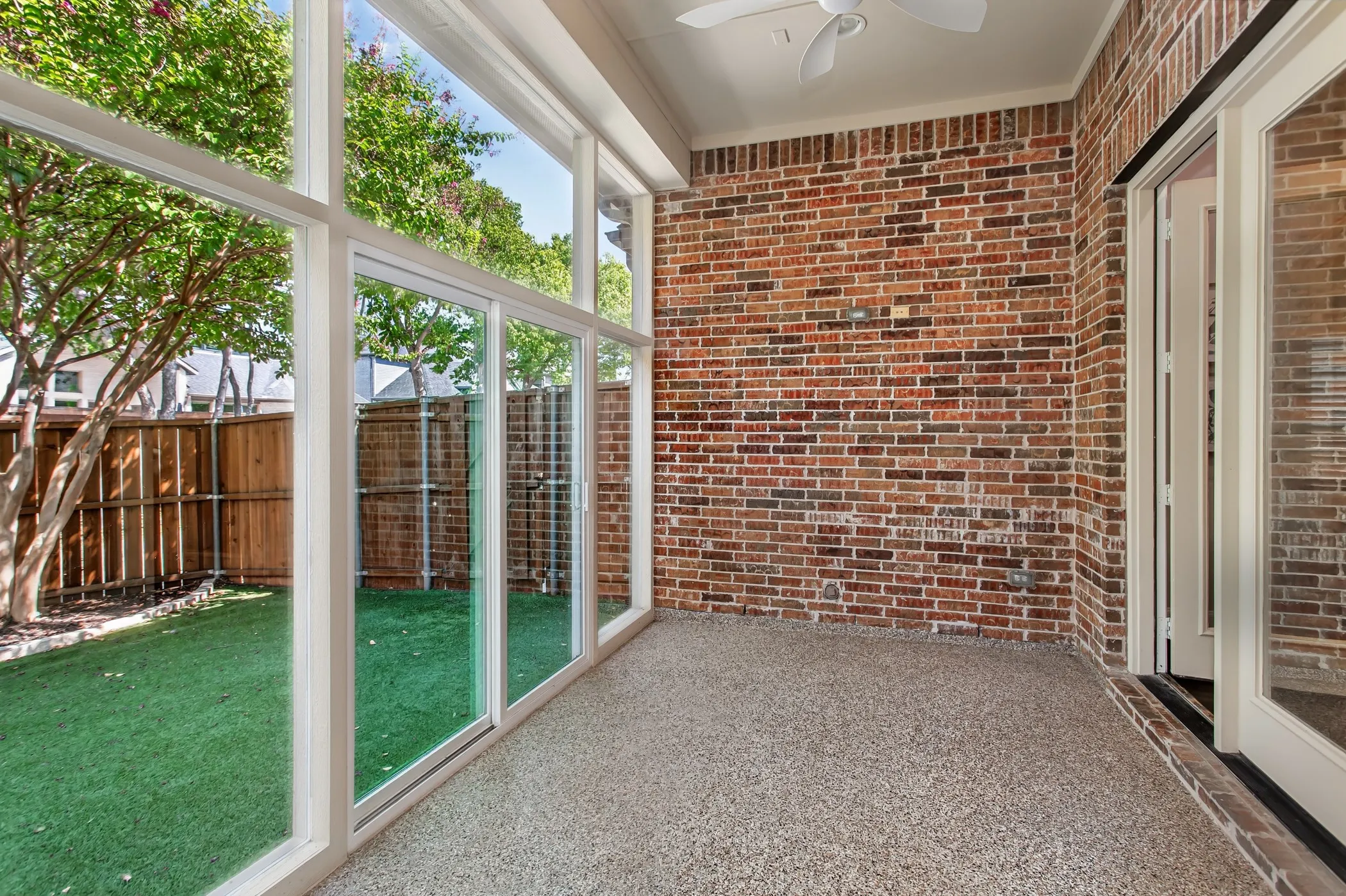Floor-to-ceiling windows and a sliding glass door open to the low-maintenance artificial turf backyard
and wood privacy fence. Gas line stubbed for a future outdoor kitchen.