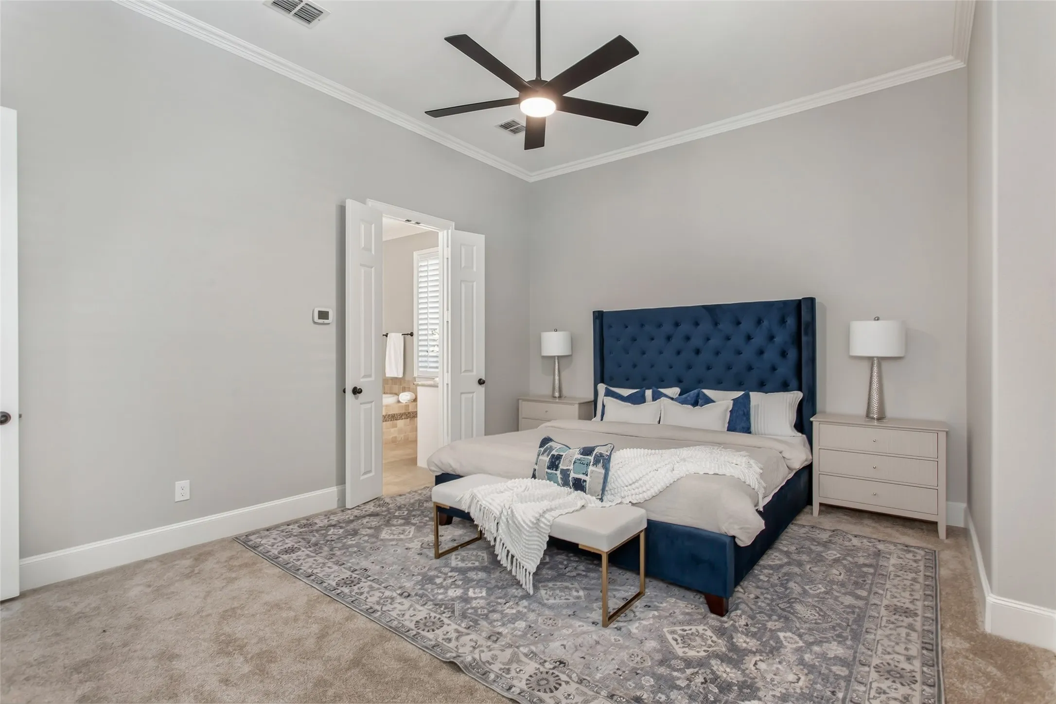 Double doors lead from the primary bedroom to the ensuite bath. Crown molding, a new 2026 ceiling
fan, new carpet, and fresh 2026 paint.