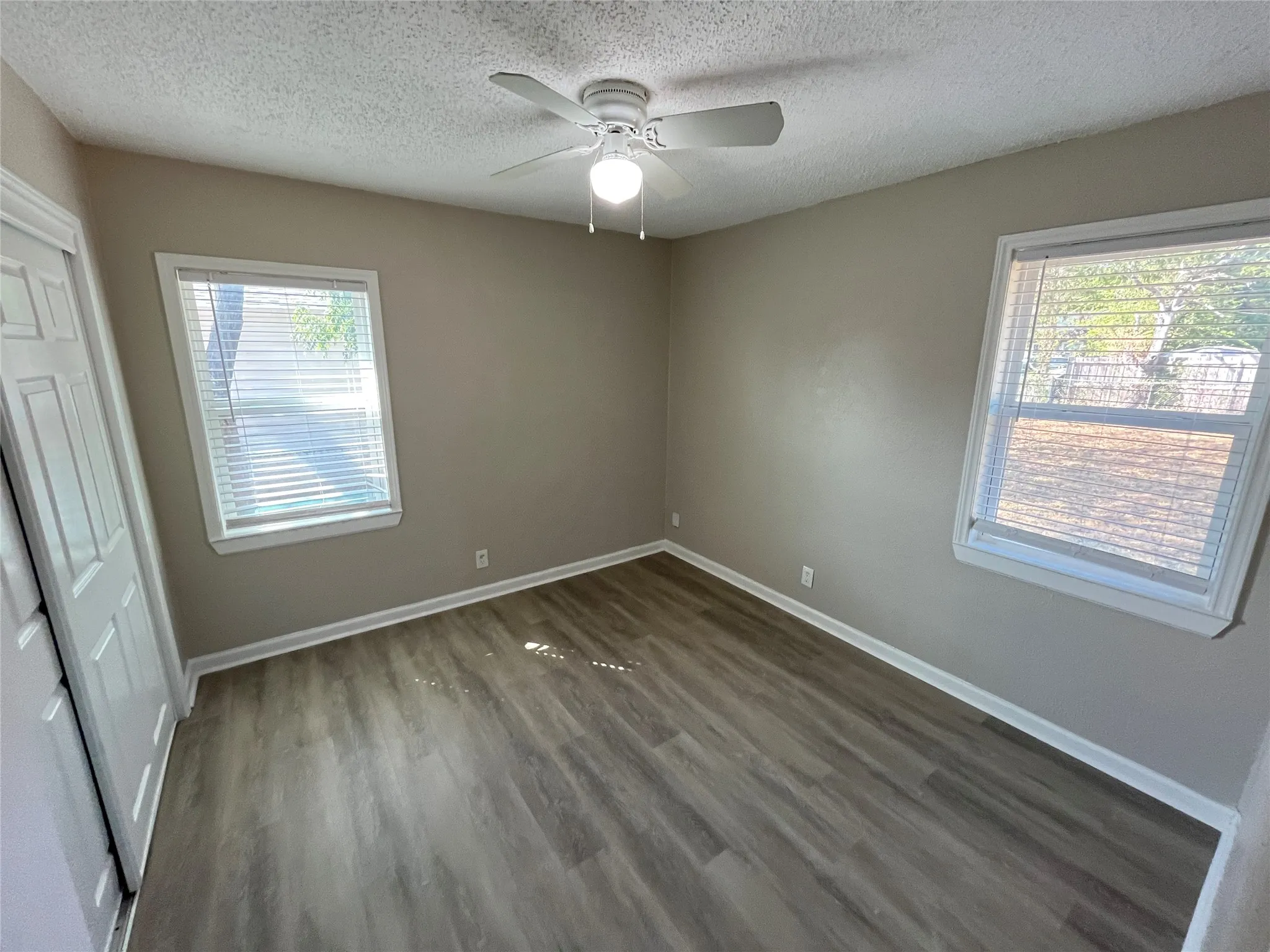 Wood-finish flooring with white trim and neutral wall tones