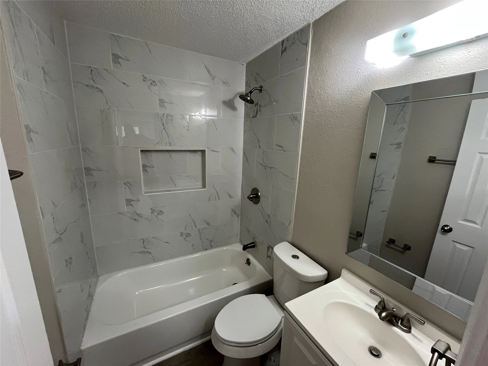 Tub and shower combination with a built-in tiled niche
