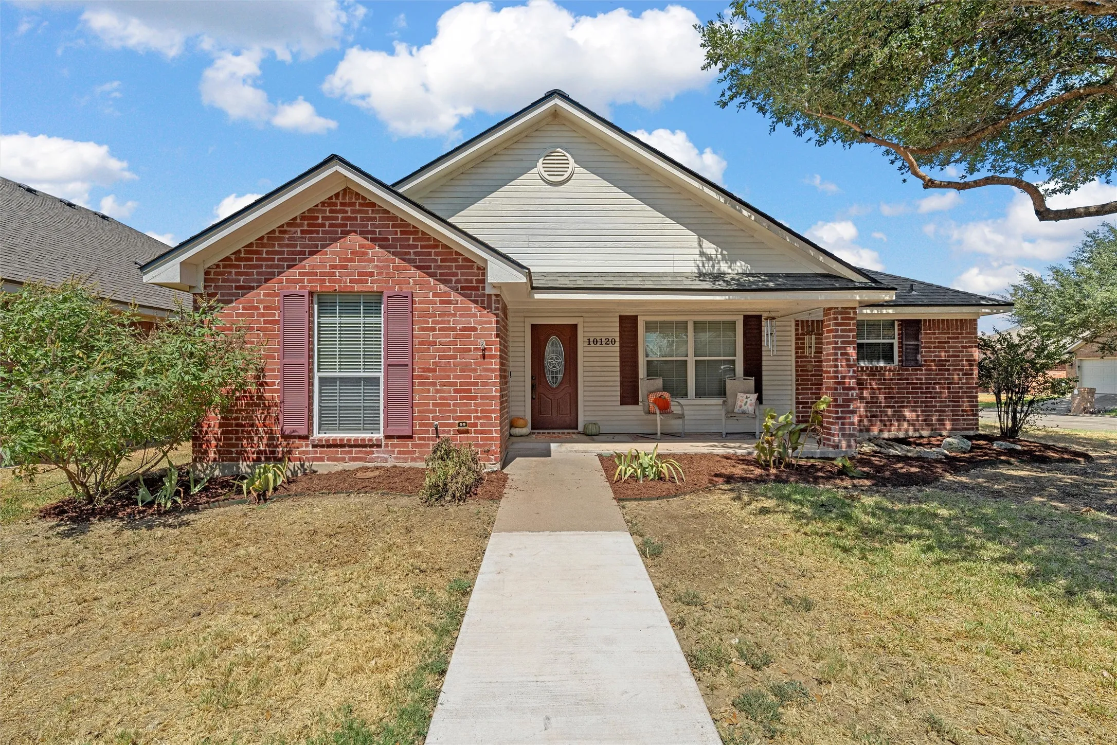 Brick and siding exterior with a covered front entry
