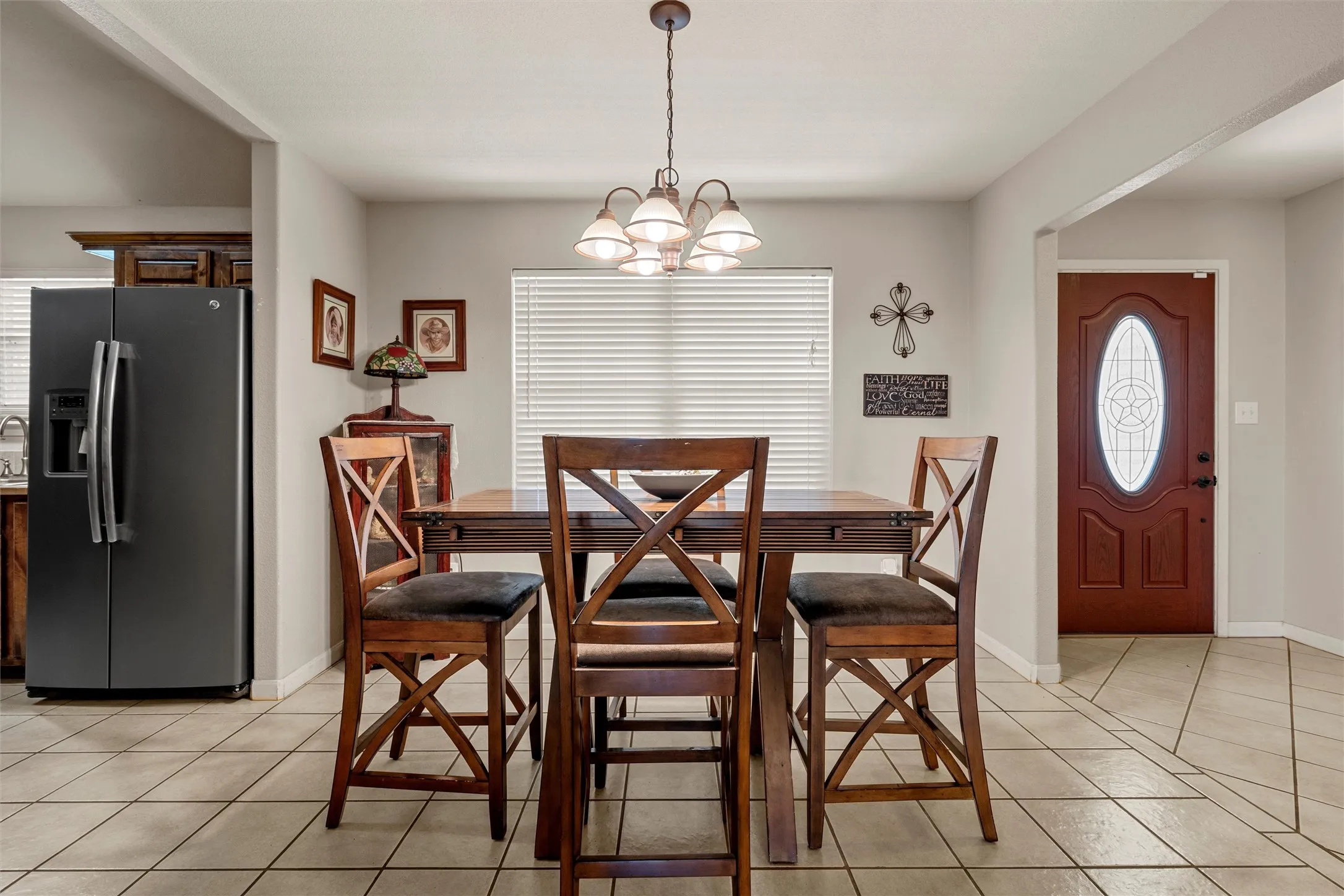 Tile flooring with decorative inlays, recessed lighting, and a chandelier fixture