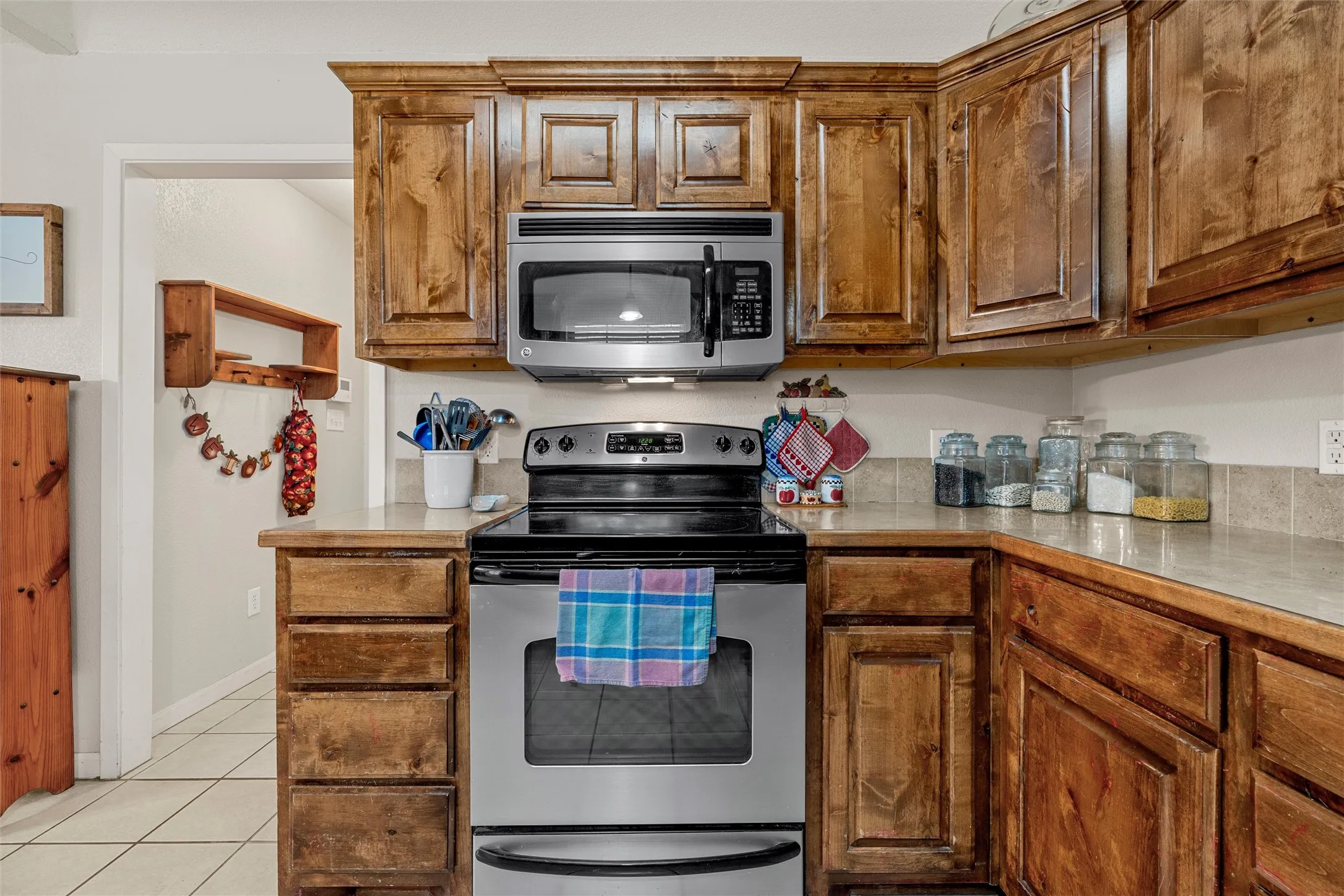 Wood-finish cabinetry paired with stainless steel appliances