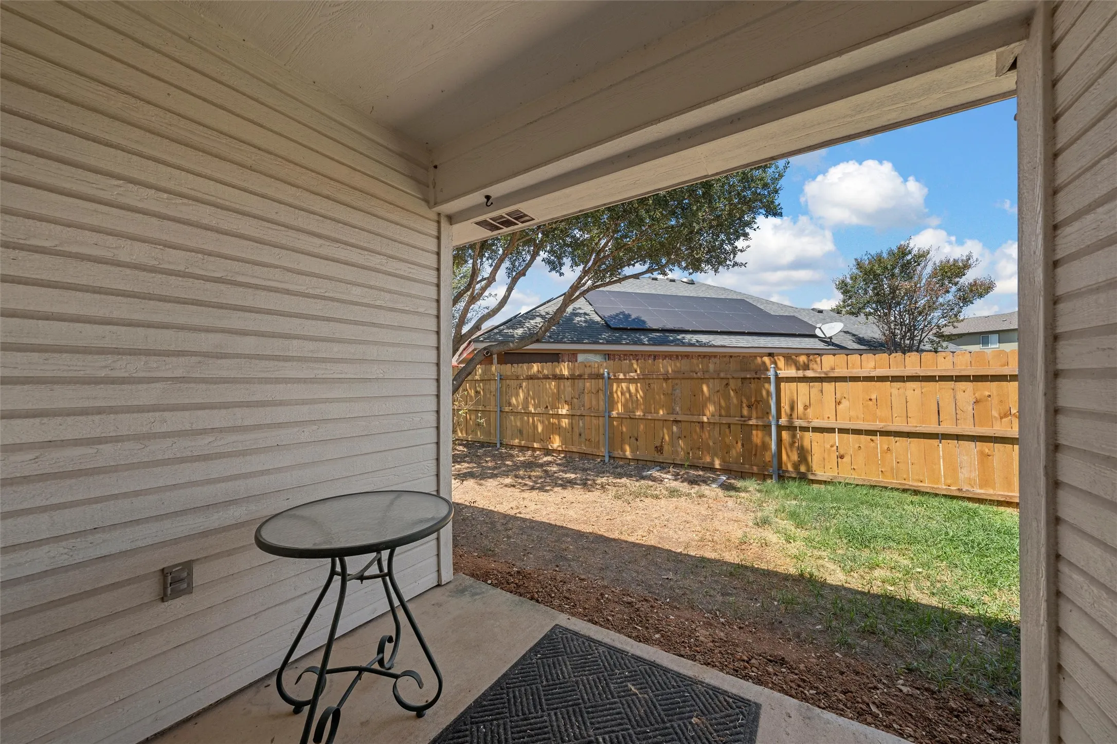 Covered concrete patio with siding exterior