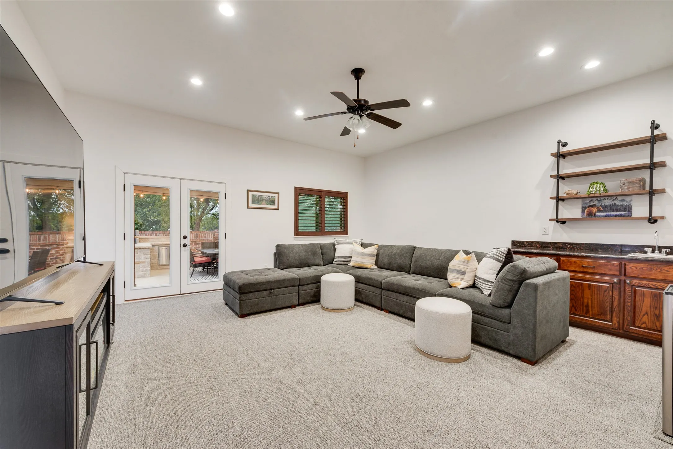 Game room with wet bar and access to backyard