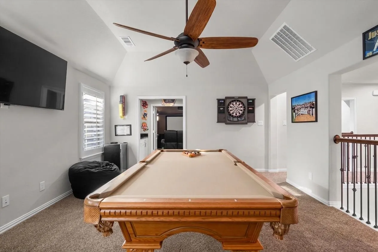 Generous open space for billiards, games, and gathering, with natural light and TV wall.