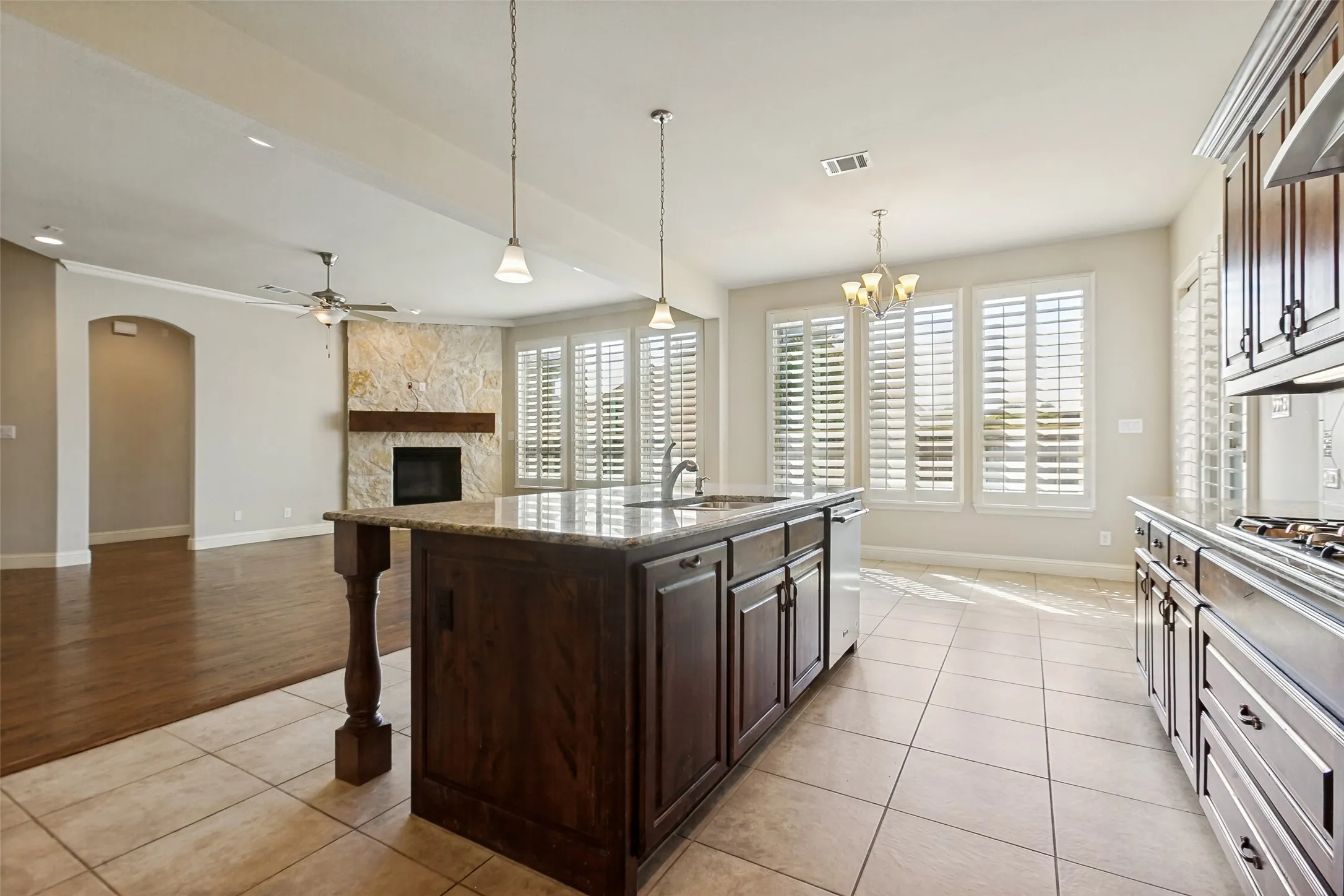 Kitchen island with an undermount sink and pendant lighting