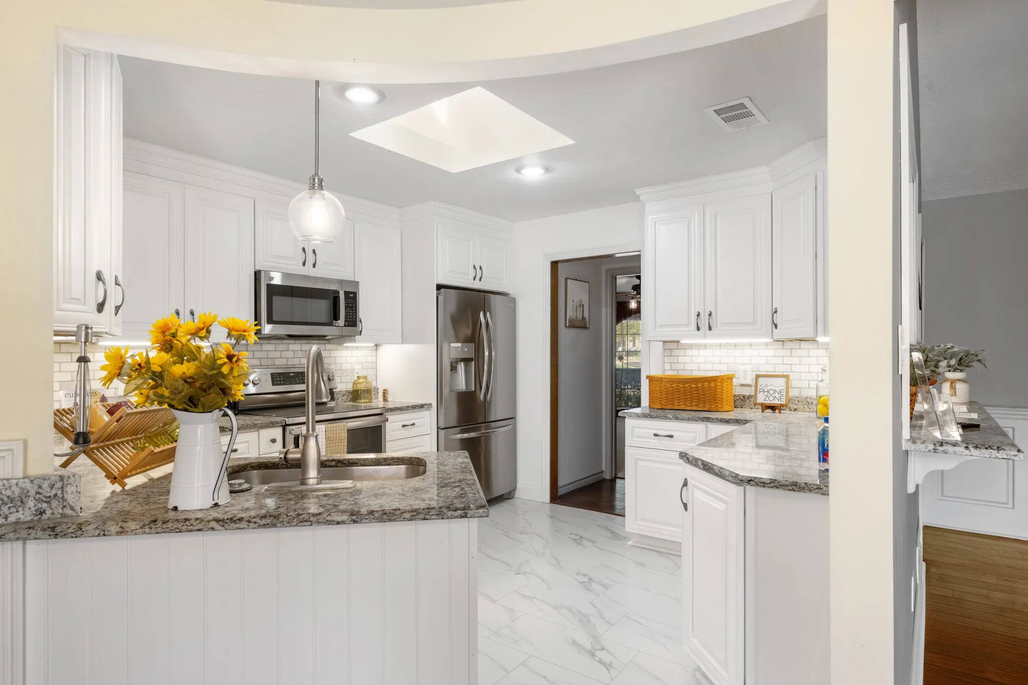 The kitchens backsplash compliments the countertops and cabinets beautifully.