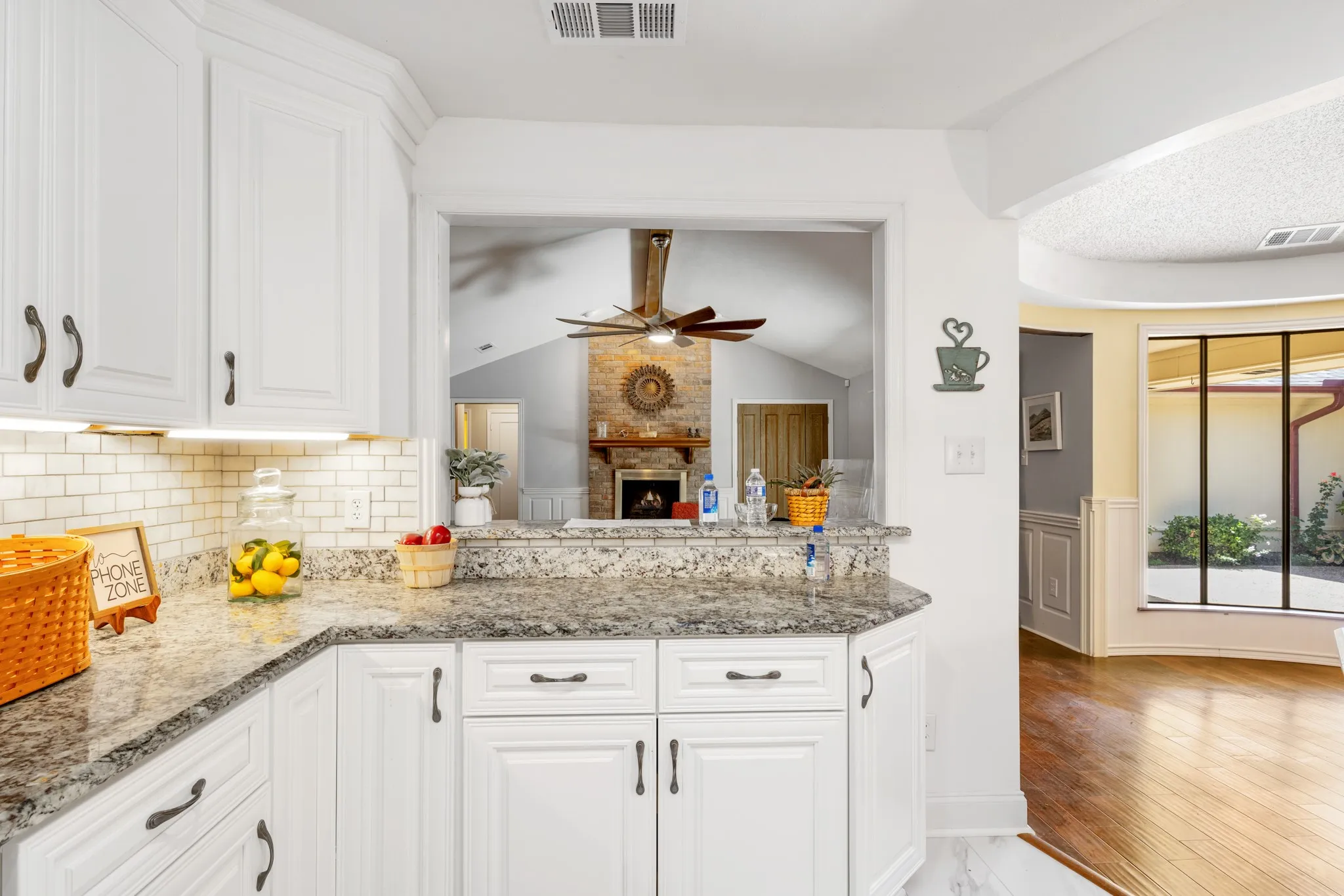 Kitchen has a breakfast bar and a view of the living room.