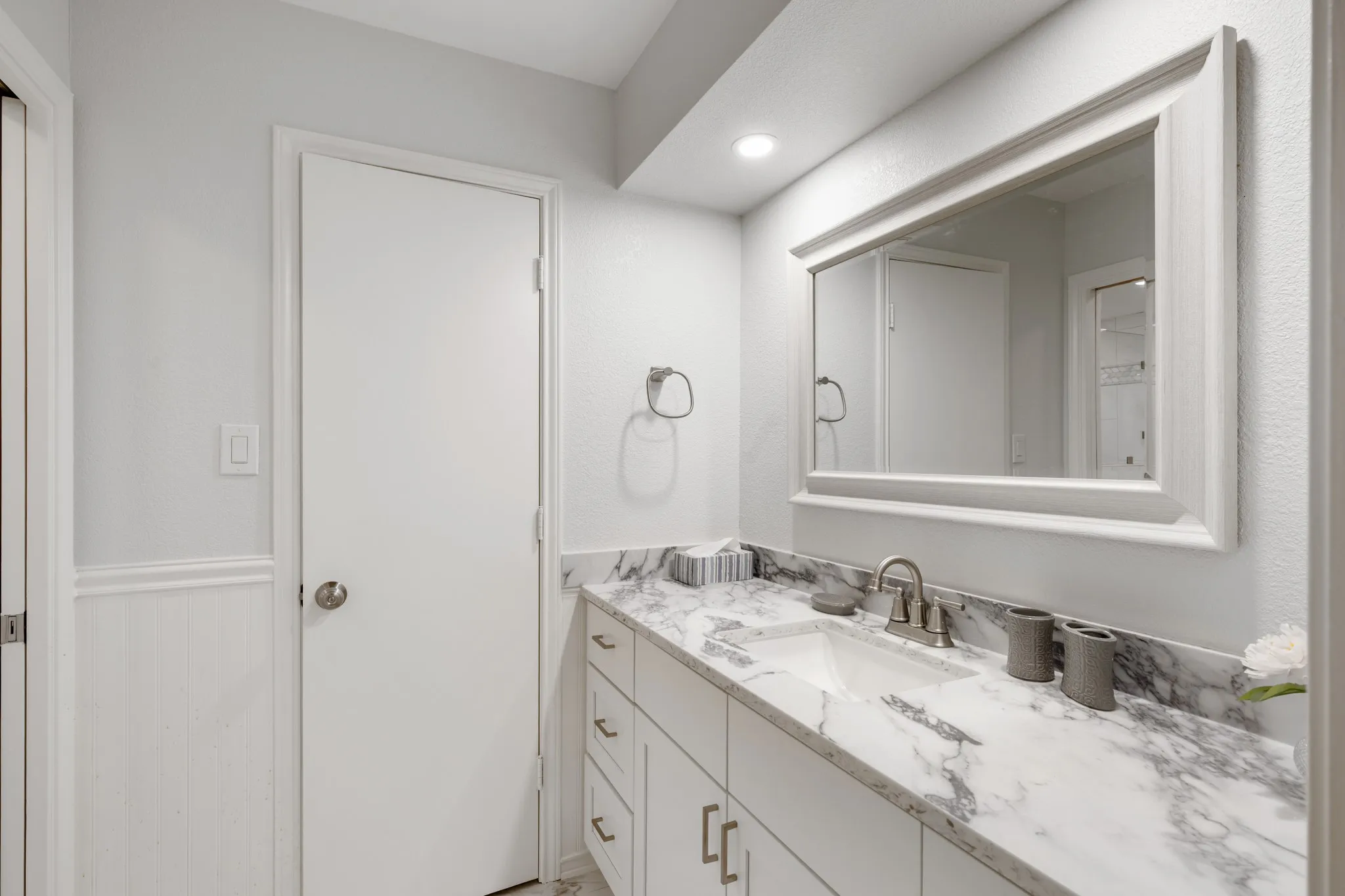 Primary bathroom features granite counters and storage built in.