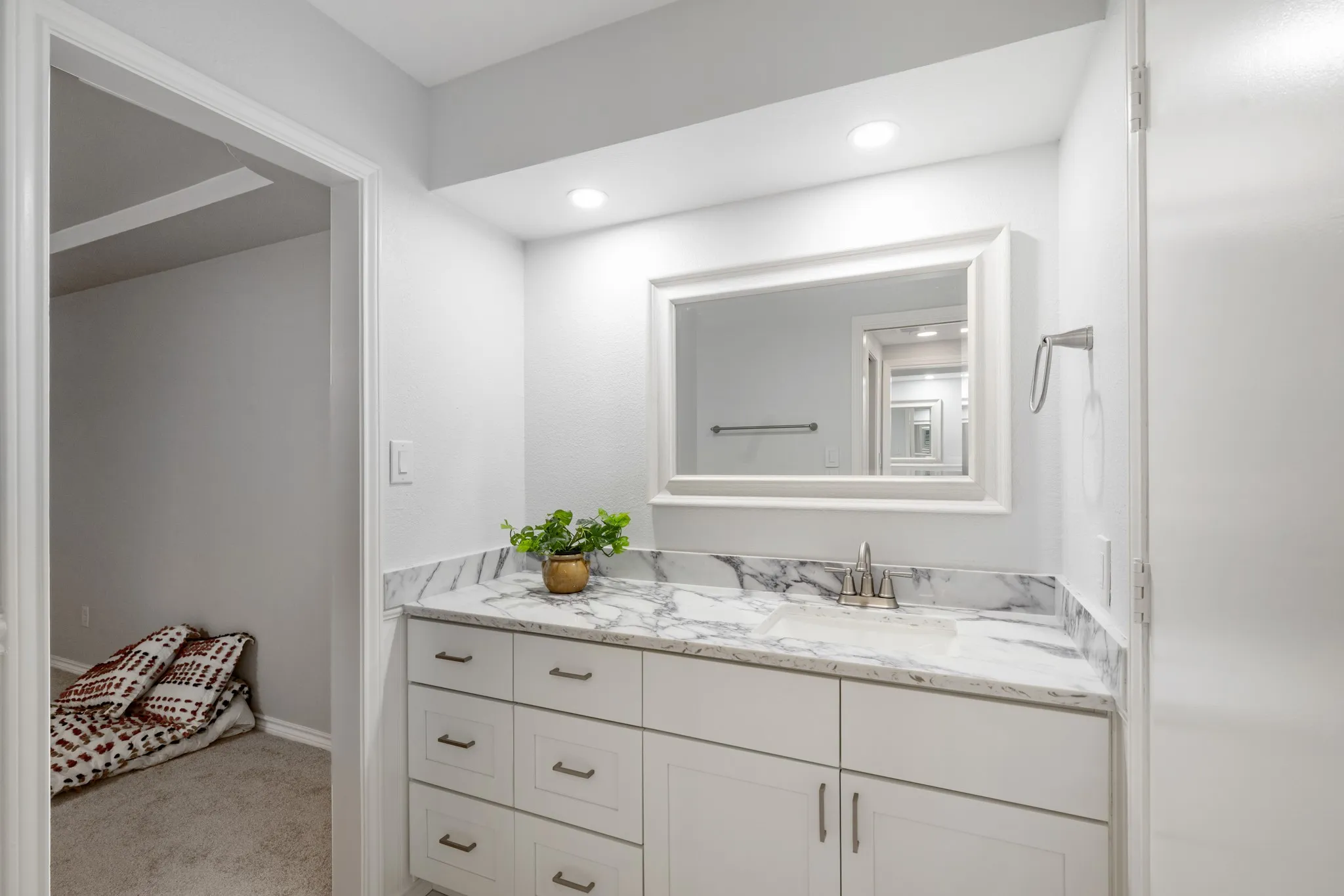 Built in storage in primary bathroom with a walk in closet.