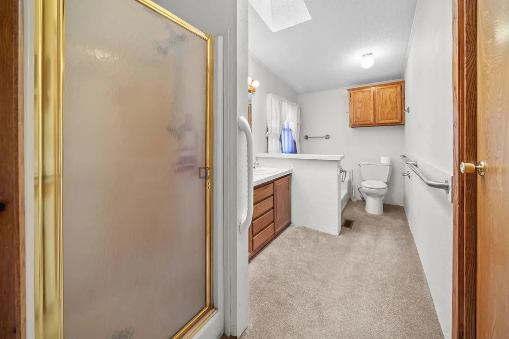 Shower enclosure with a gold-tone frame and frosted glass