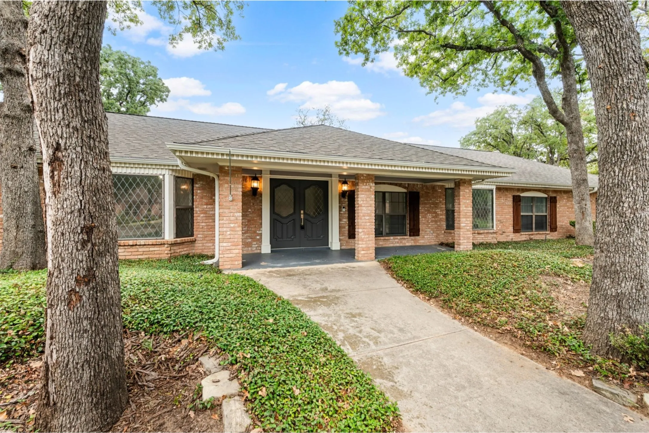 Welcoming front entry with mature landscaping