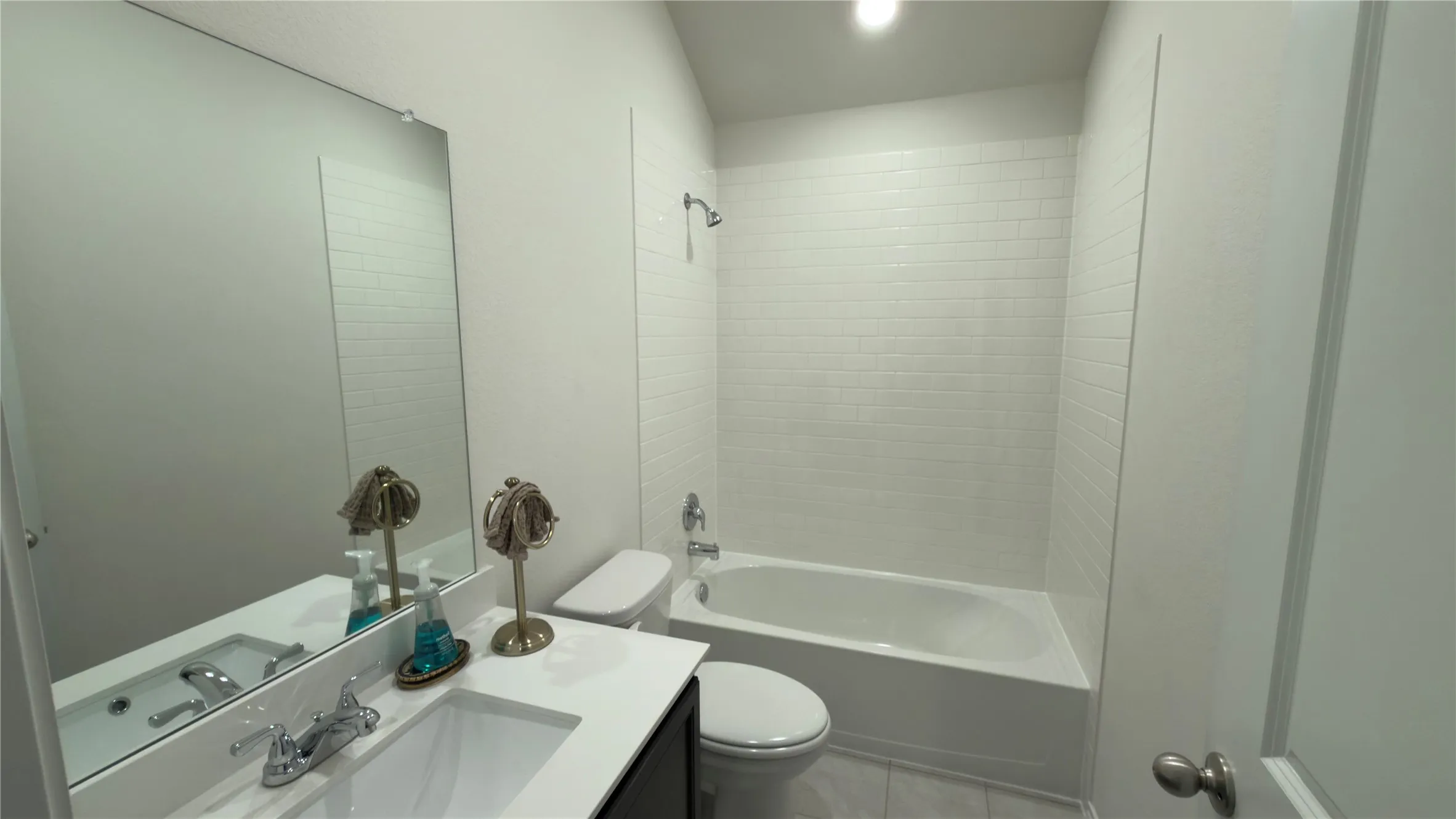 Modern vanity with an integrated sink, polished chrome faucet, and expansive wall-mounted mirror