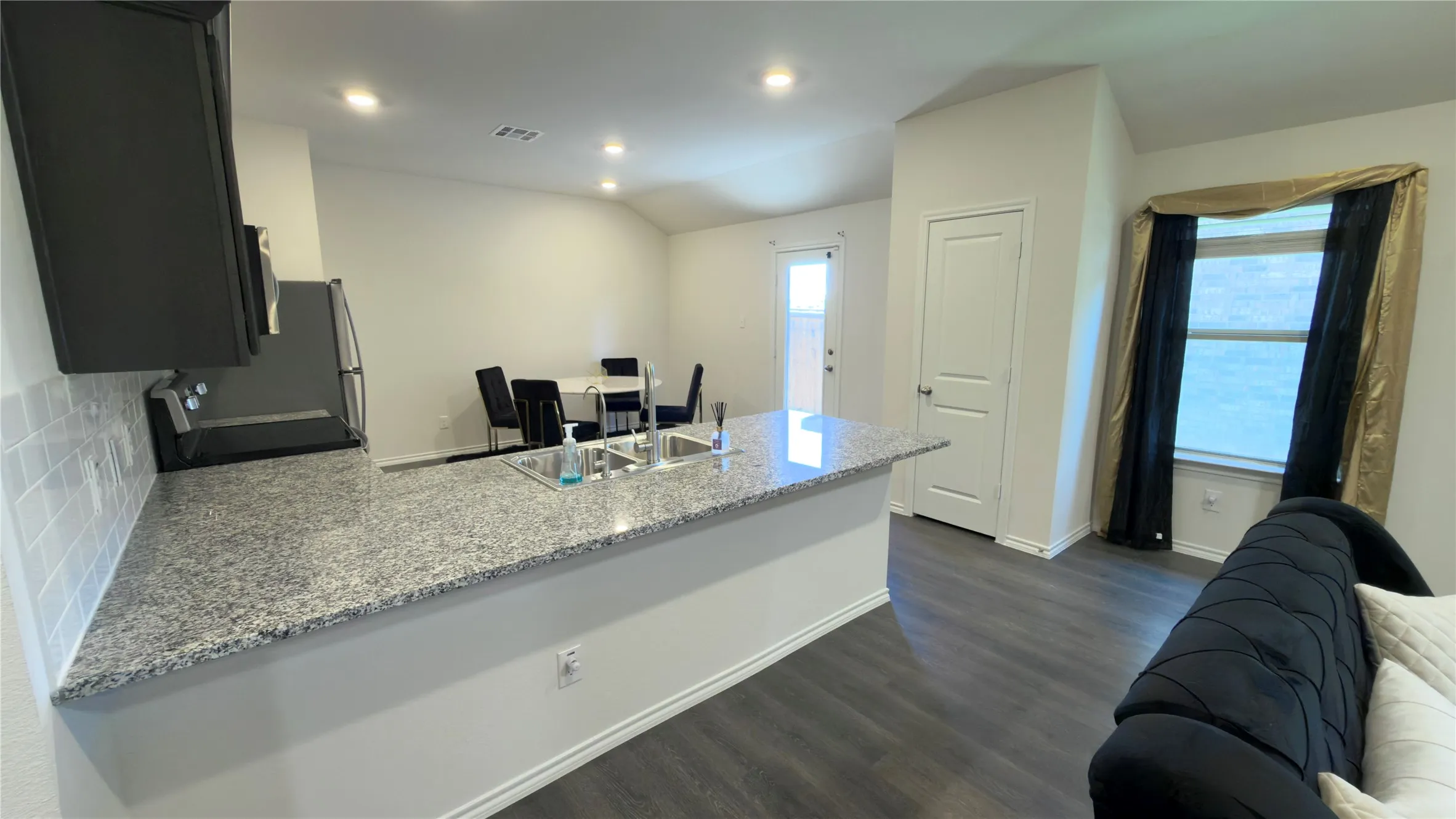 Kitchen island with granite-finish countertop and undermount double sink