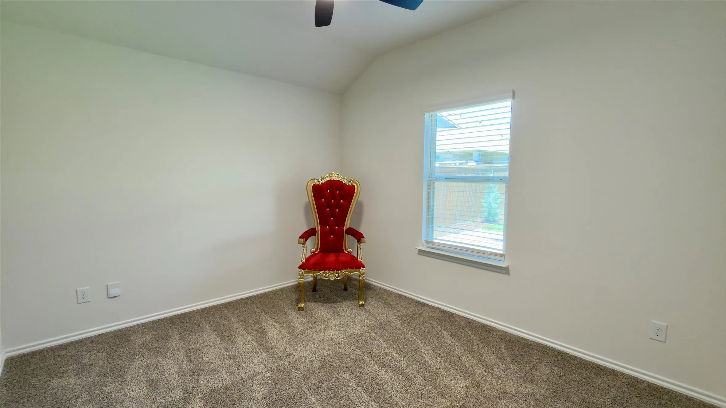 Neutral-toned walls and carpeted flooring in a room featuring a window with blinds, baseboards, and a ceiling fan
