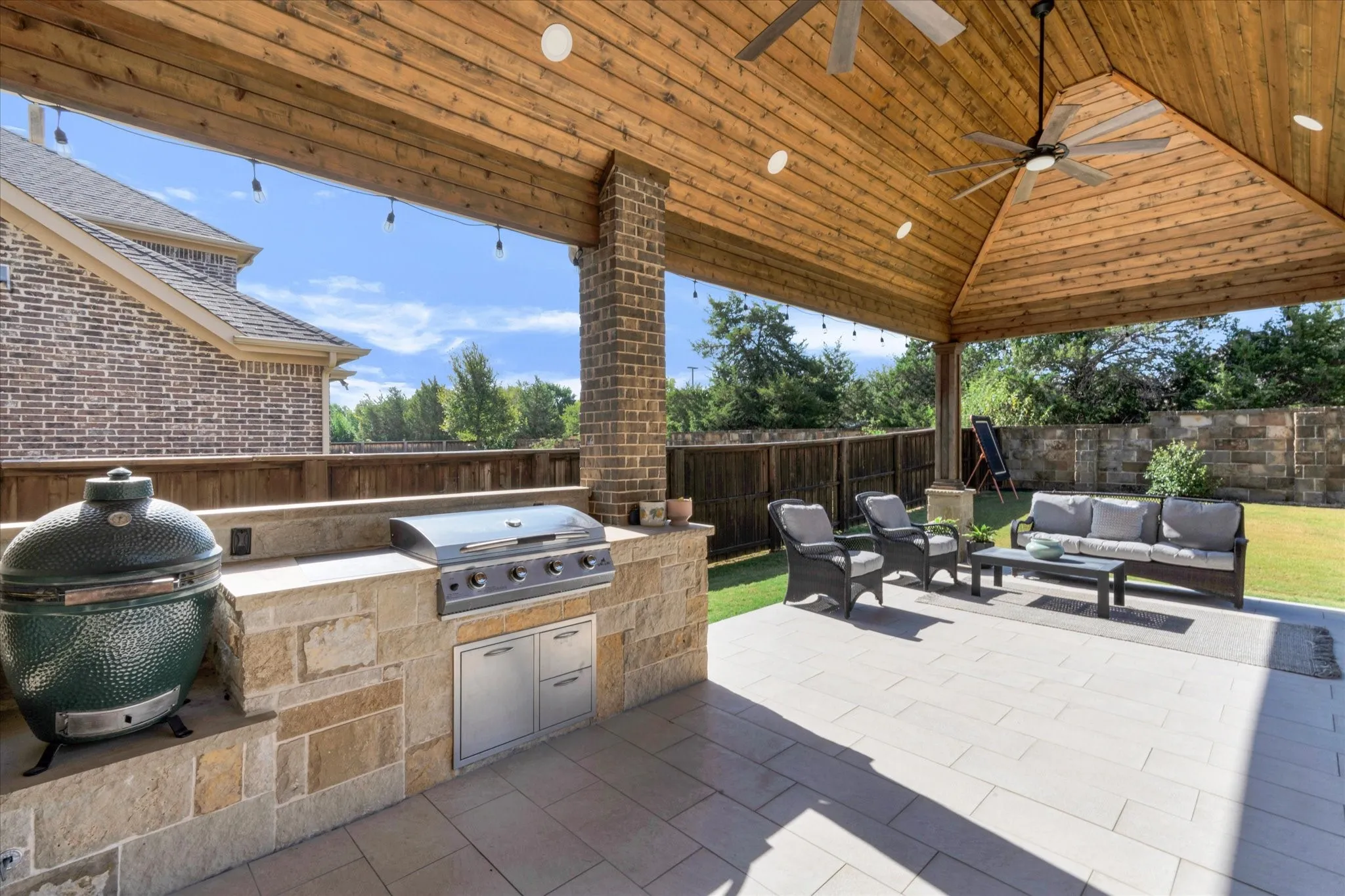 Covered patio with a natural wood ceiling, recessed lighting, and ceiling fans