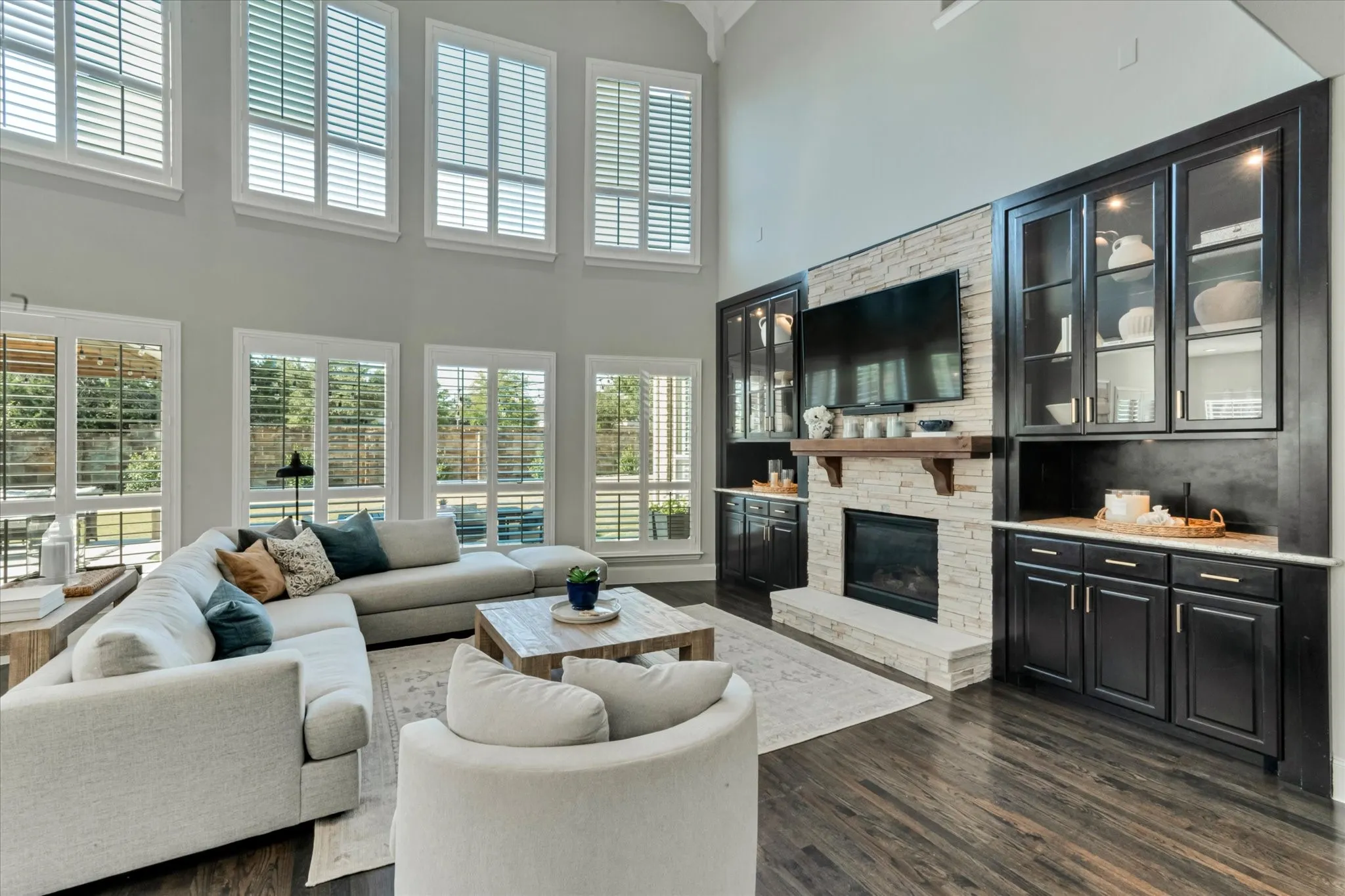 Two-story living area with dark wood-finish flooring