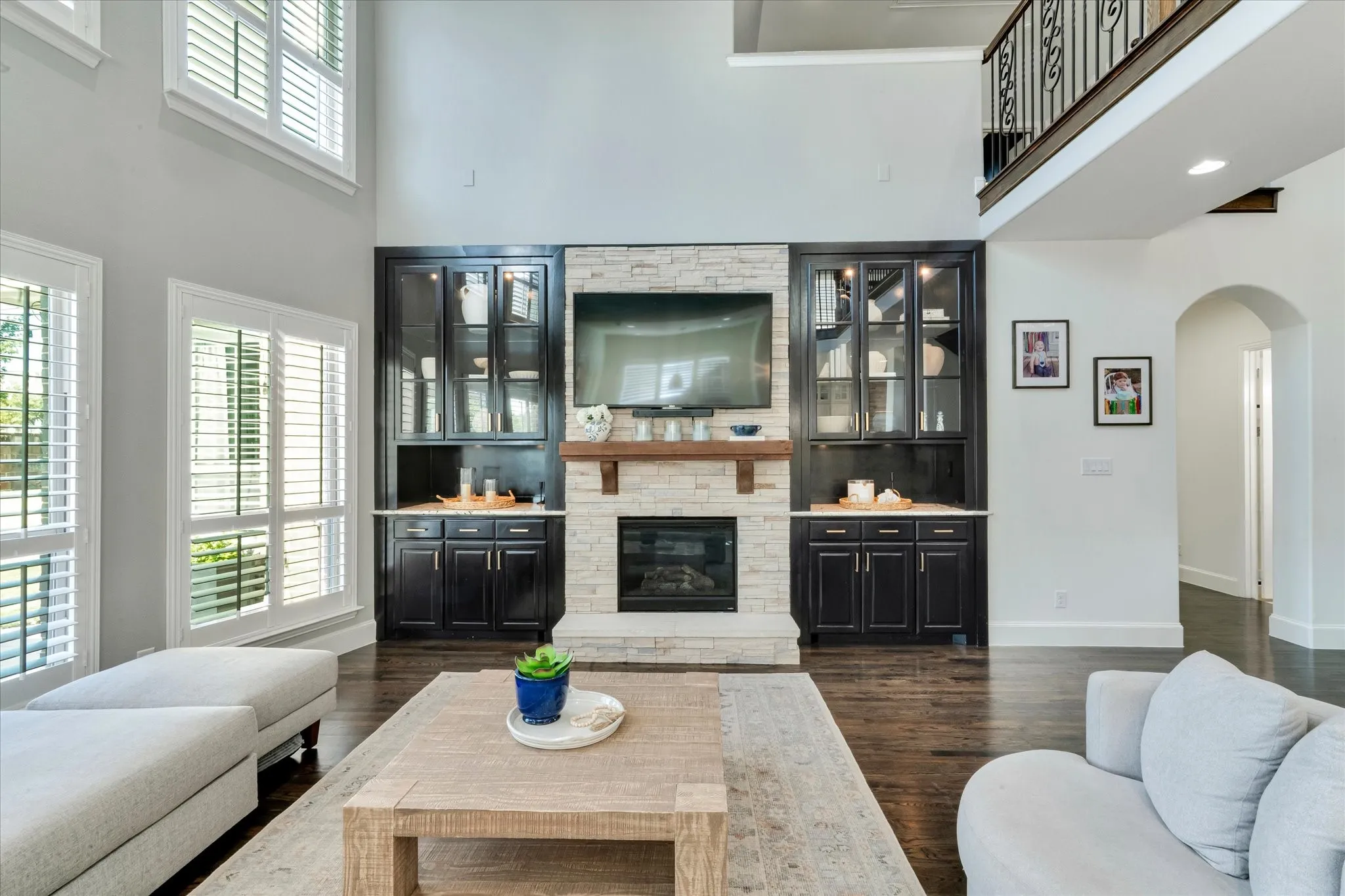 Two-story living area with dark wood-finish flooring