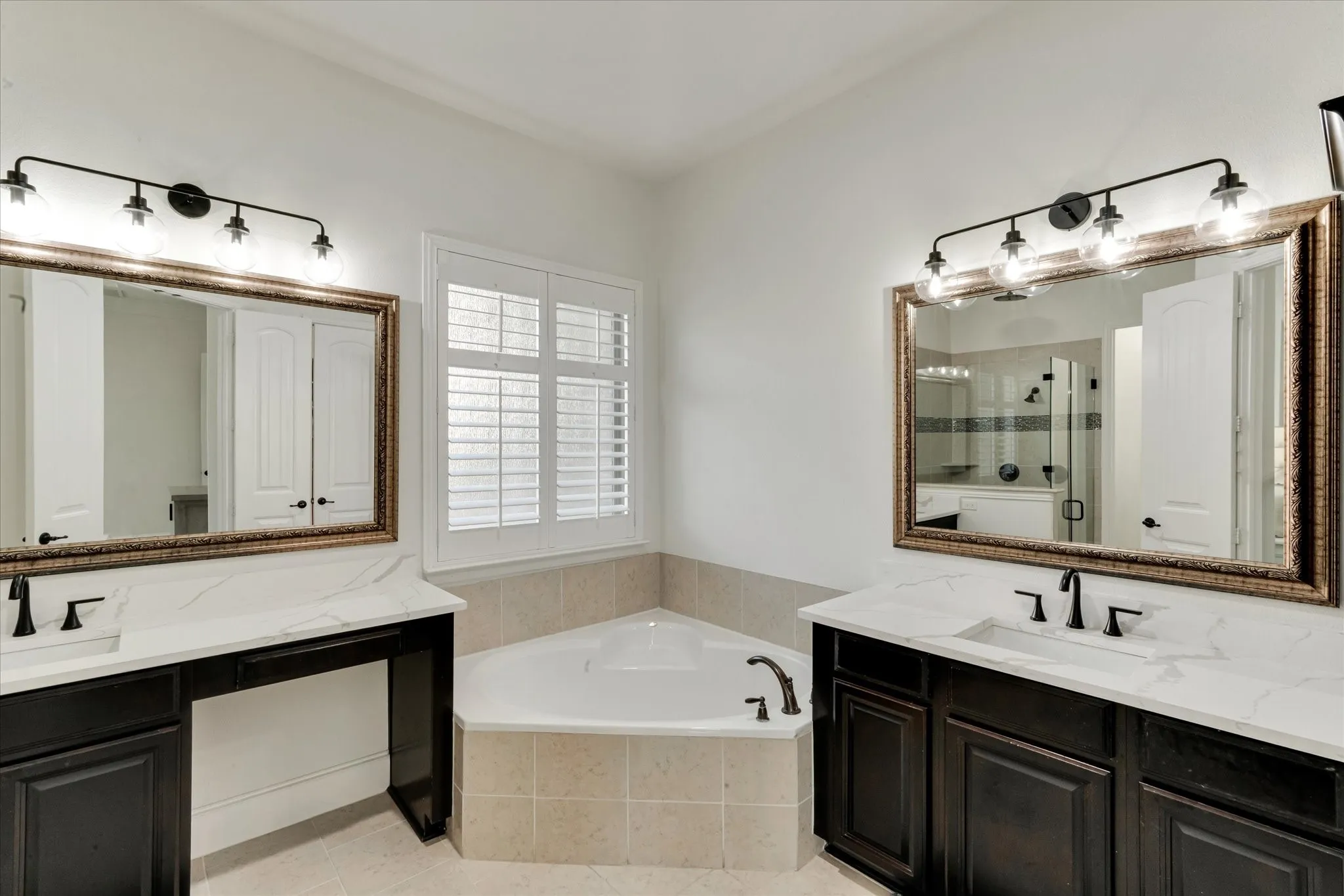 Dual vanities with undermount sinks and dark wood cabinetry