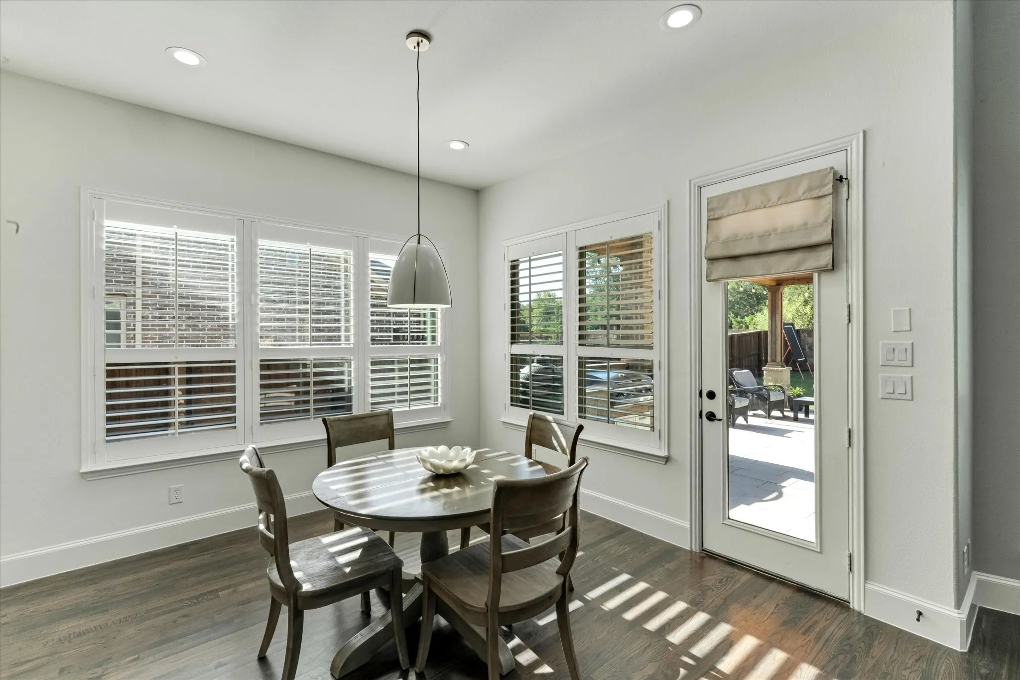 Wood-finish flooring with white baseboards