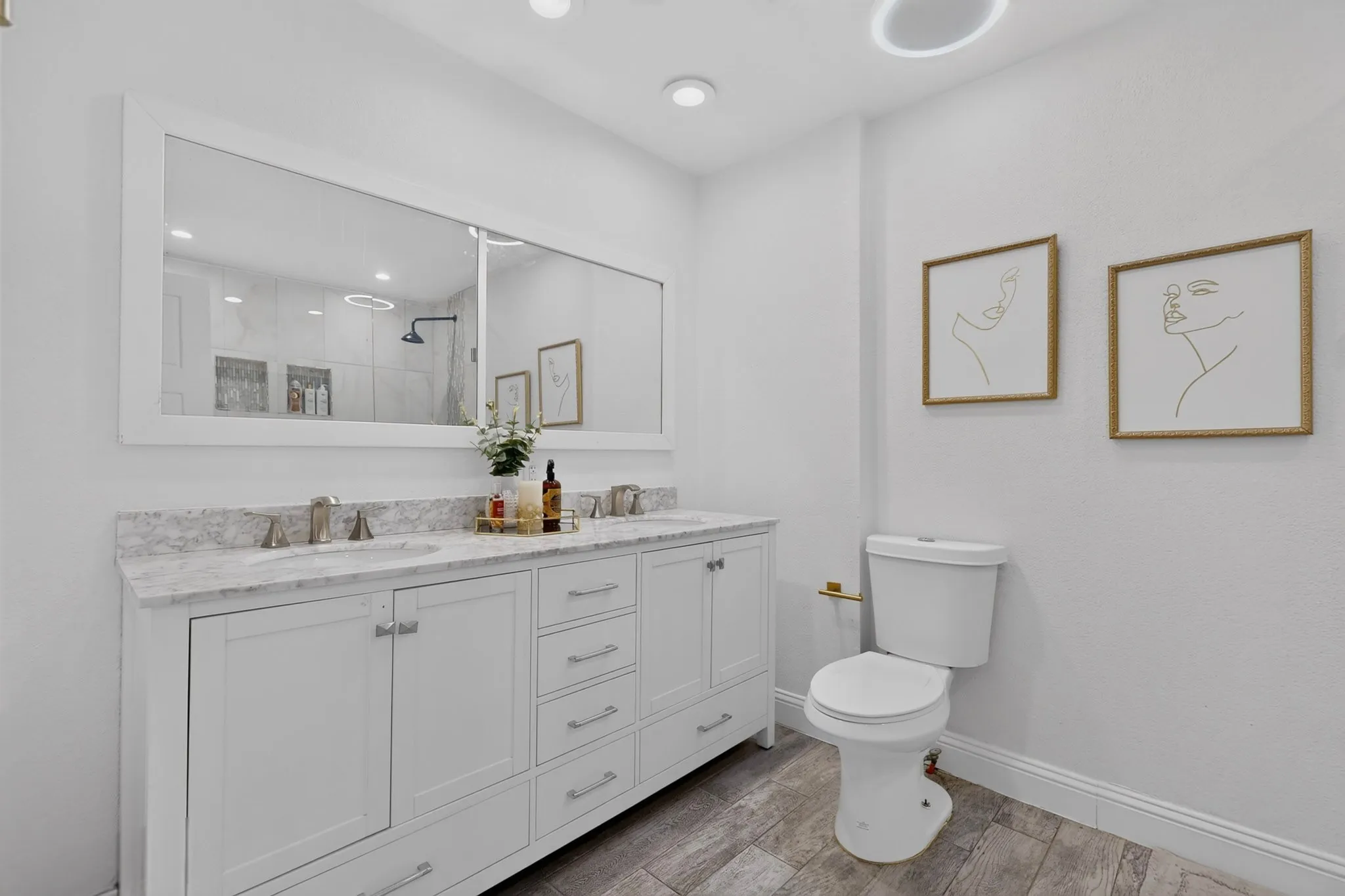 Dual vanity with white cabinetry, a light-toned countertop, and undermount sinks