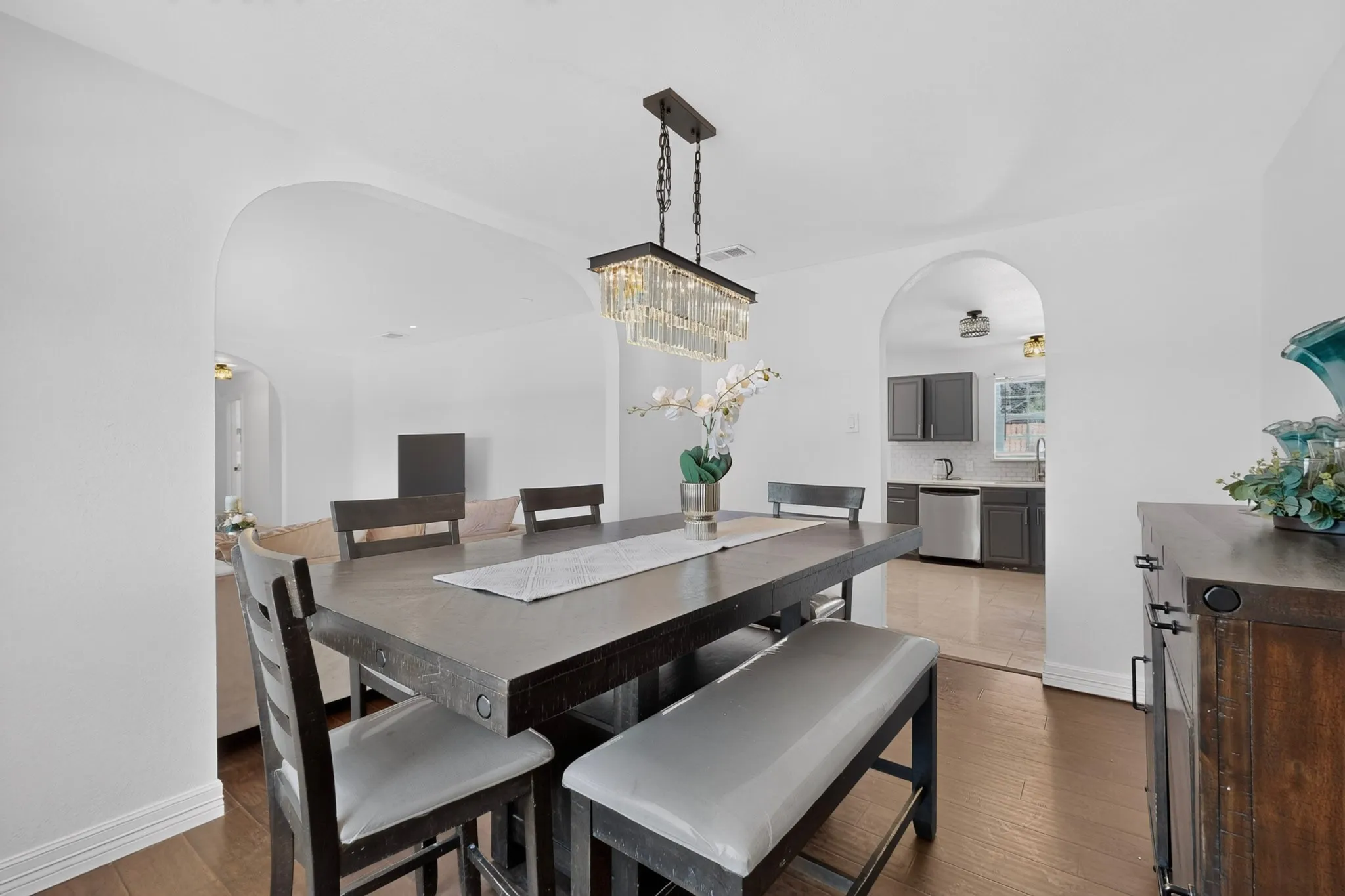 Recessed lighting, wood-finish flooring, and arched doorways