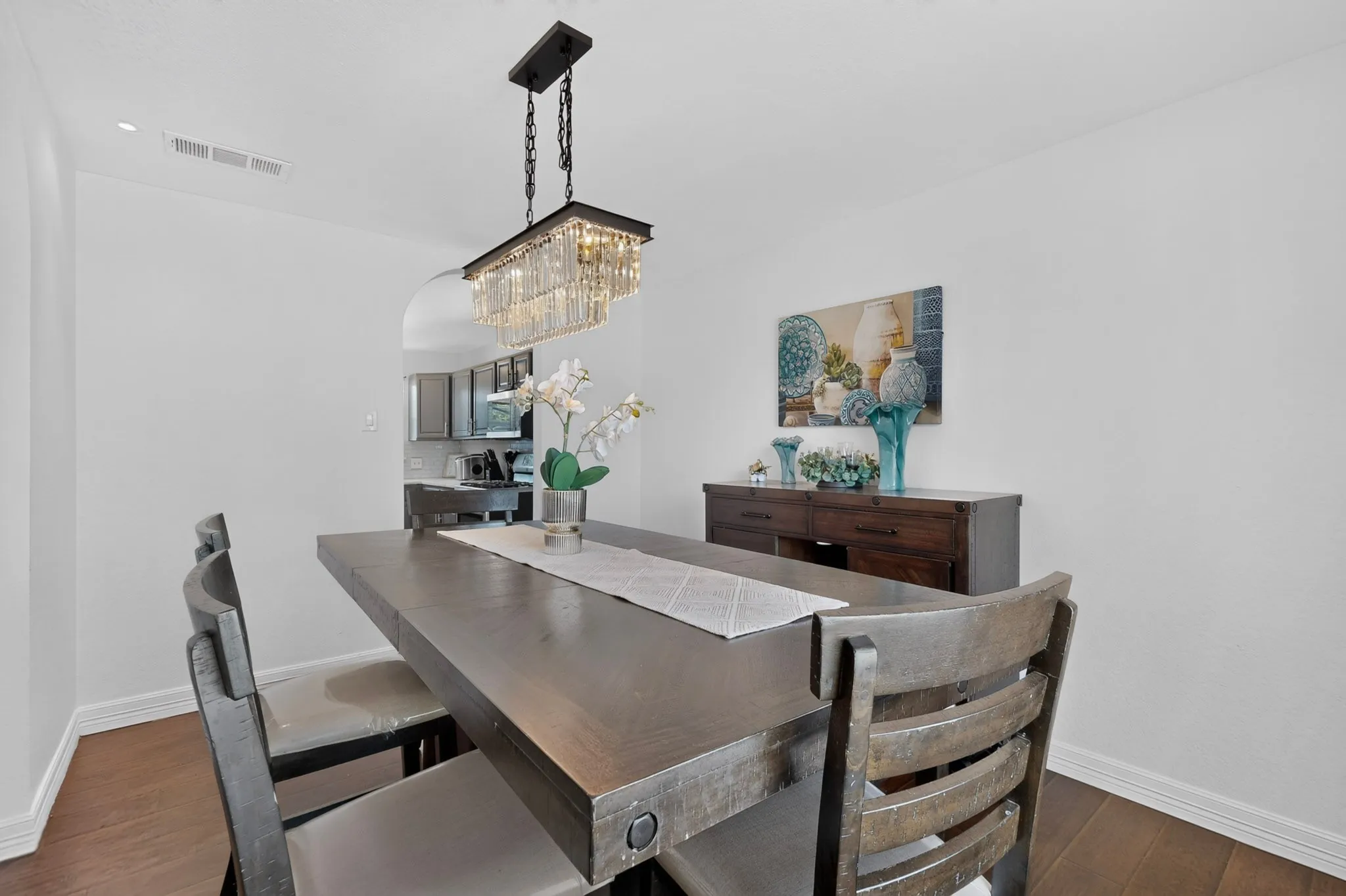 Recessed lighting, wood-finish flooring, and arched doorway