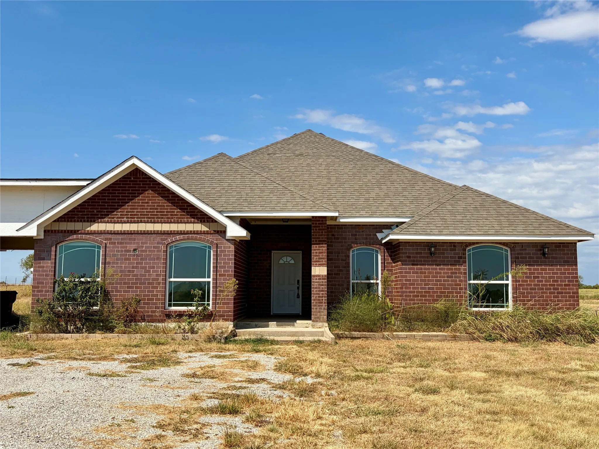 Beautiful brick work, covered front porch, stylish windows.