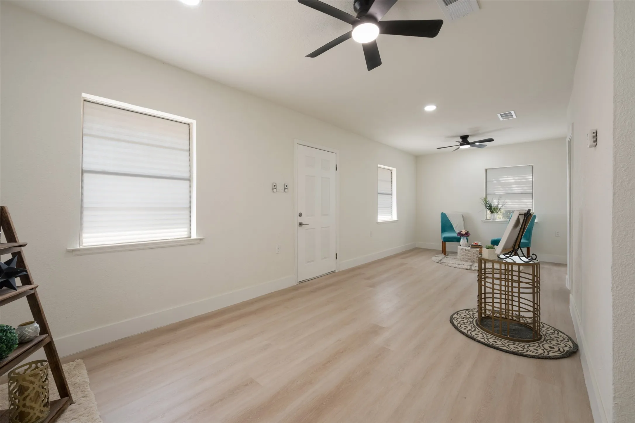 Recessed lighting, wood-finish flooring, multiple windows, and ceiling fans