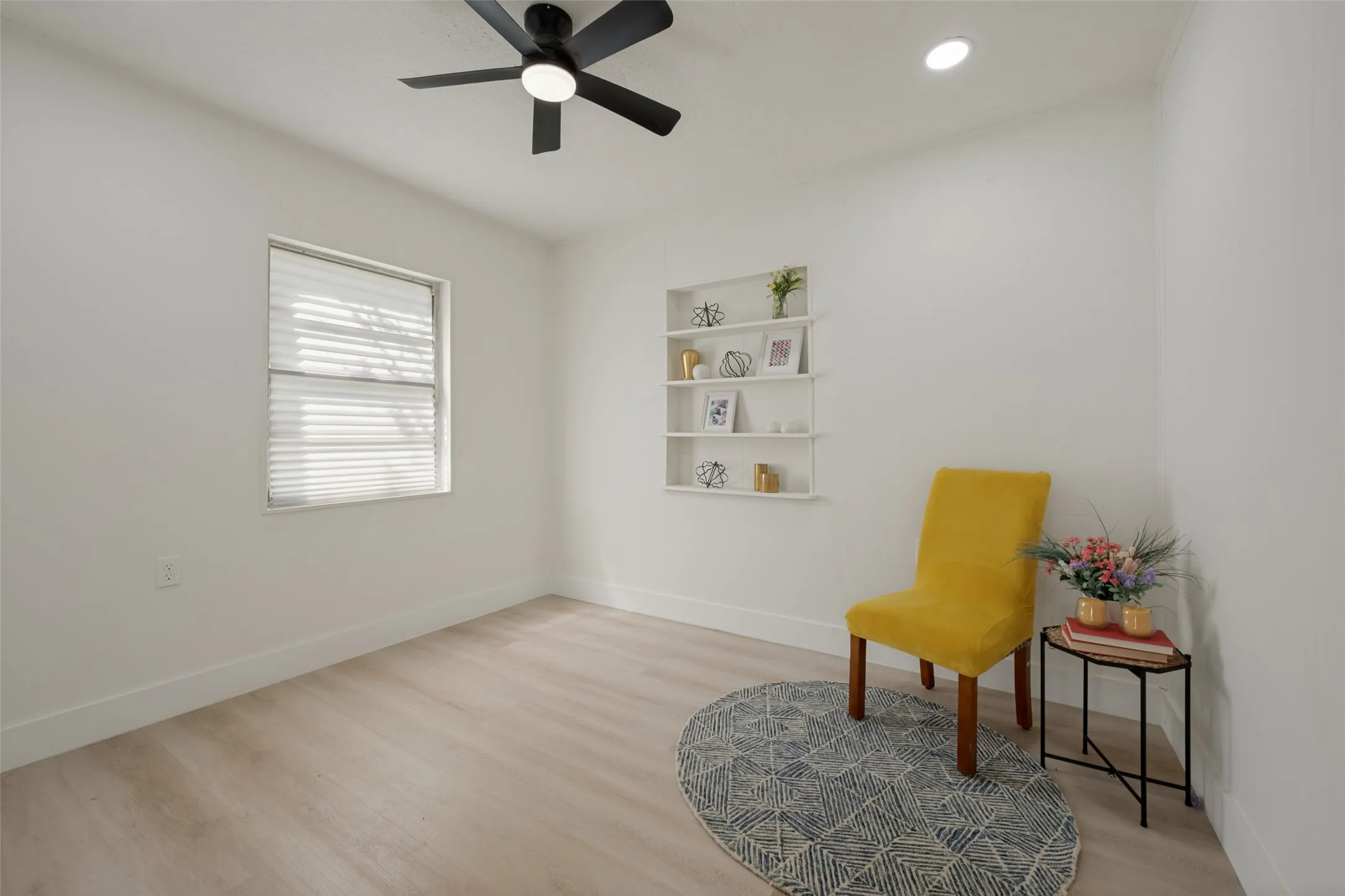 Recessed lighting, ceiling fan, built-in shelving, wood-finish flooring, and window with blinds
