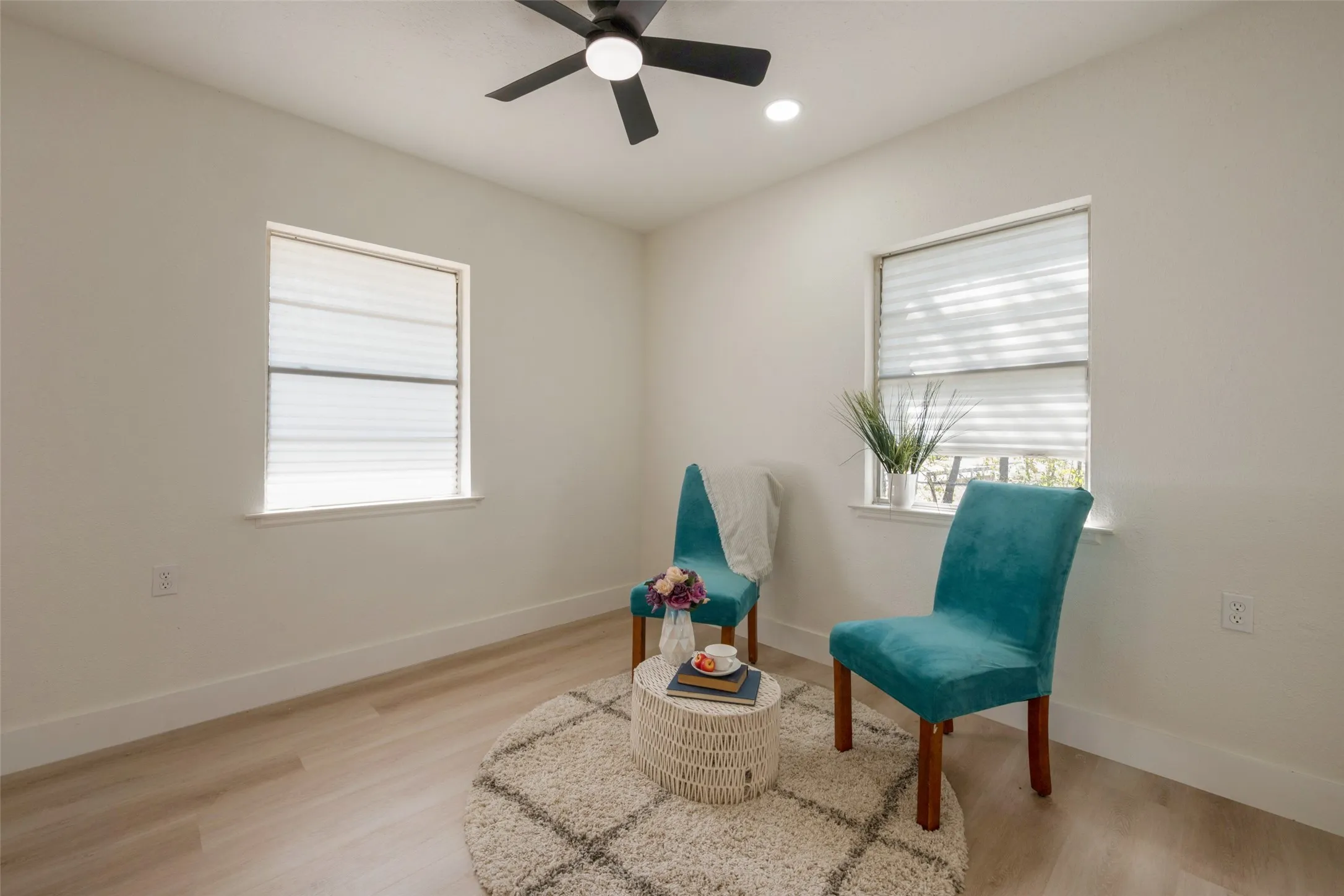 Recessed lighting, ceiling fan, wood-finish flooring, white walls, and window treatments